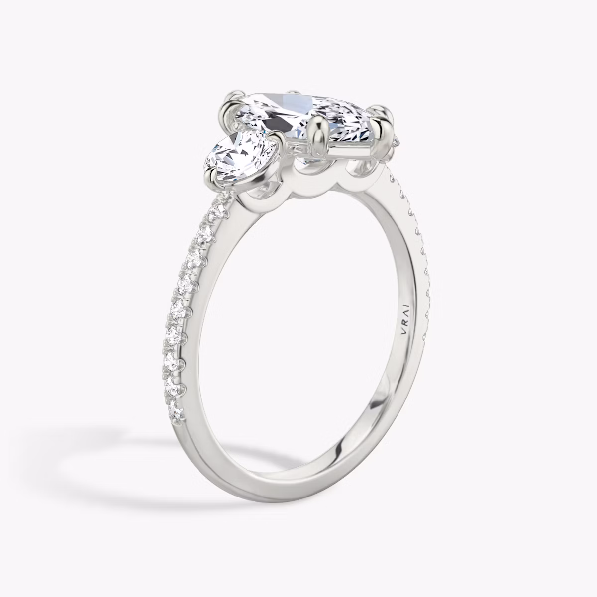 The Three Stone | Marquise | Platinum | bandAccent: Pavé | sideStoneCarat: 0.25ct | sideStoneShape: Round Brilliant | diamondOrientation: vertical | caratWeight: other