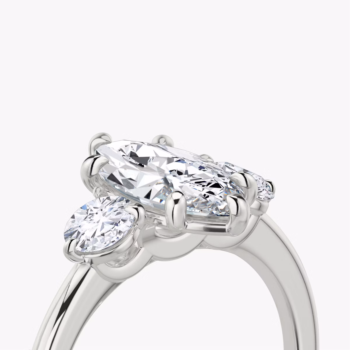 The Three Stone | Marquise | Platinum | bandAccent: Plain | sideStoneCarat: 0.25ct | sideStoneShape: Round Brilliant | diamondOrientation: vertical | caratWeight: other