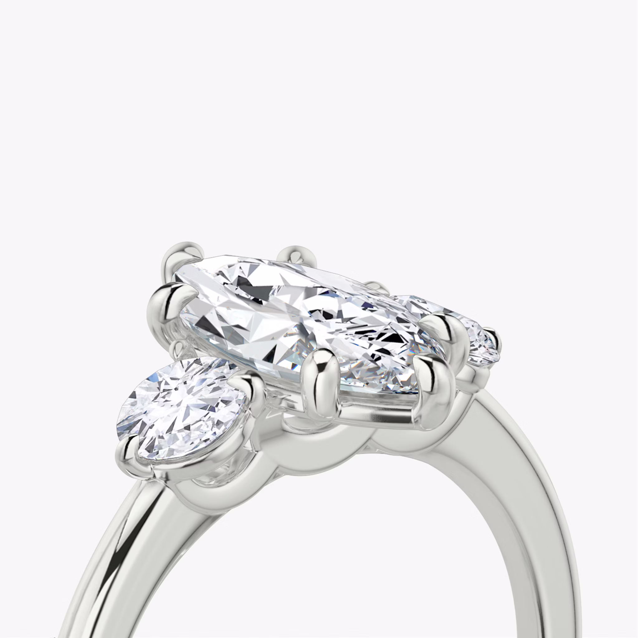 The Three Stone | Marquise | 18k | White Gold | bandAccent: Plain | sideStoneCarat: 0.25ct | sideStoneShape: Round Brilliant | diamondOrientation: vertical | caratWeight: other