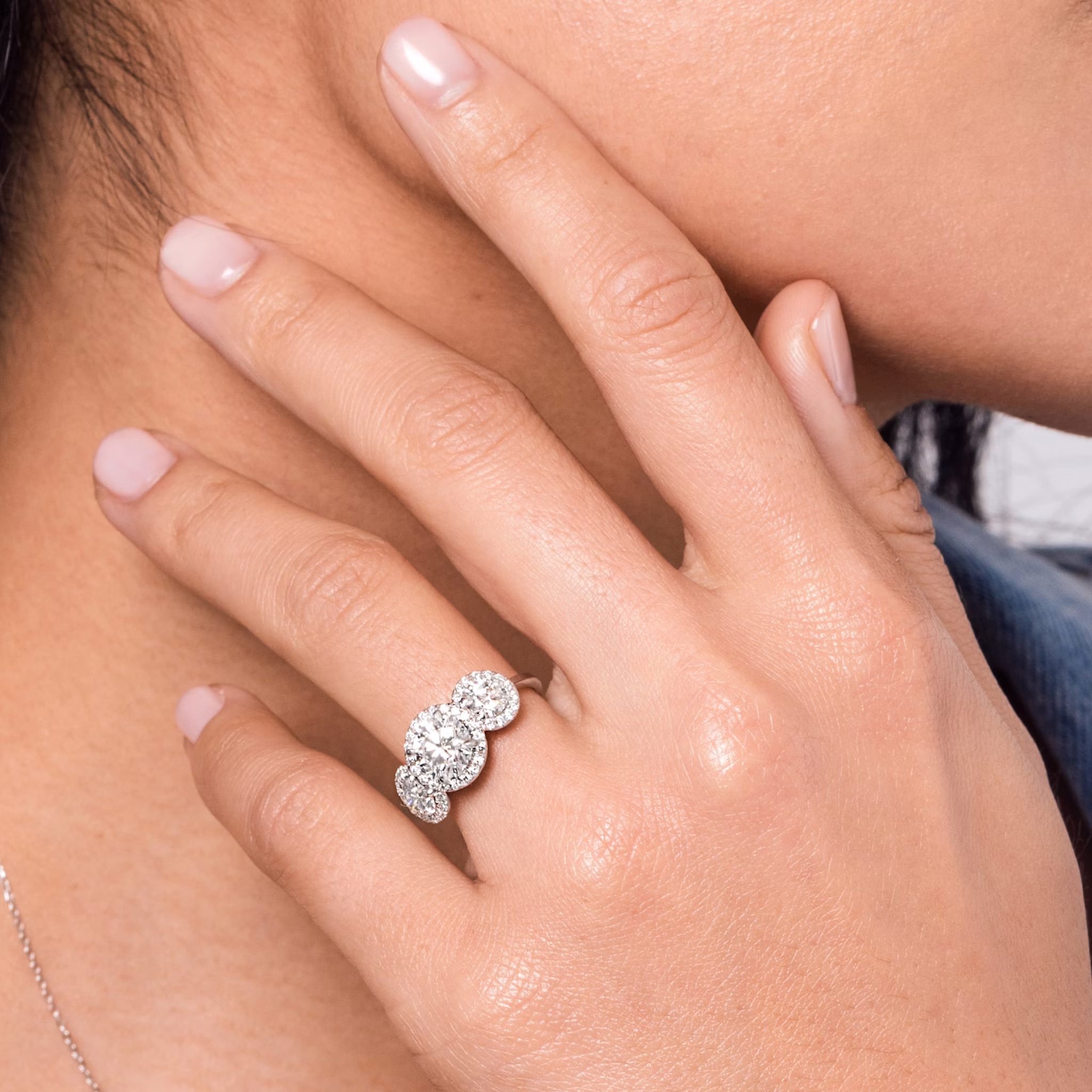 The Three Stone Halo | Round Brilliant | 18k | White Gold | bandAccent: Plain | caratWeight: other | sideStoneCarat: 0.25ct | diamondOrientation: vertical