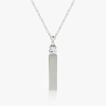 0.25-carat round brilliant diamond mounted above a sleek sterling silver bar, modern pendant necklace design.