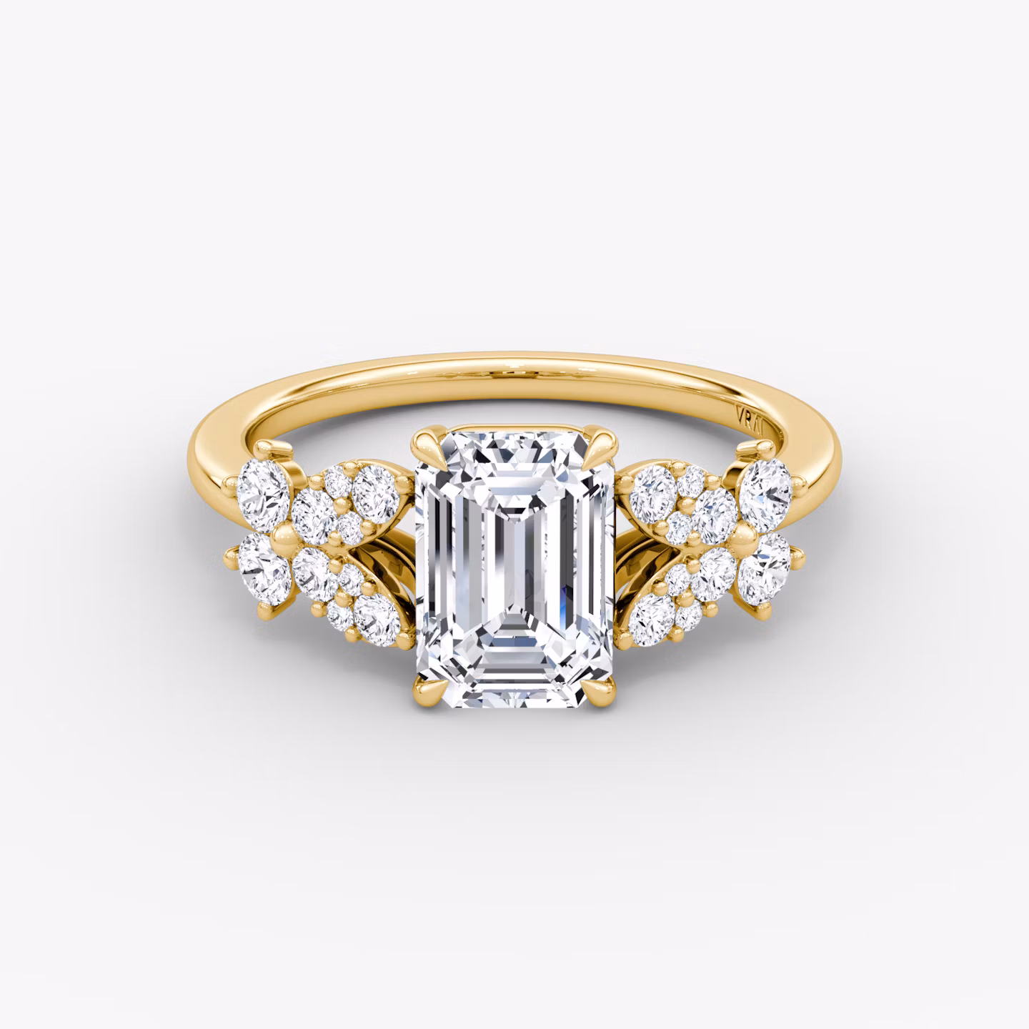 Front view of a signature floral emerald engagement ring in plain yellow gold on a white background.