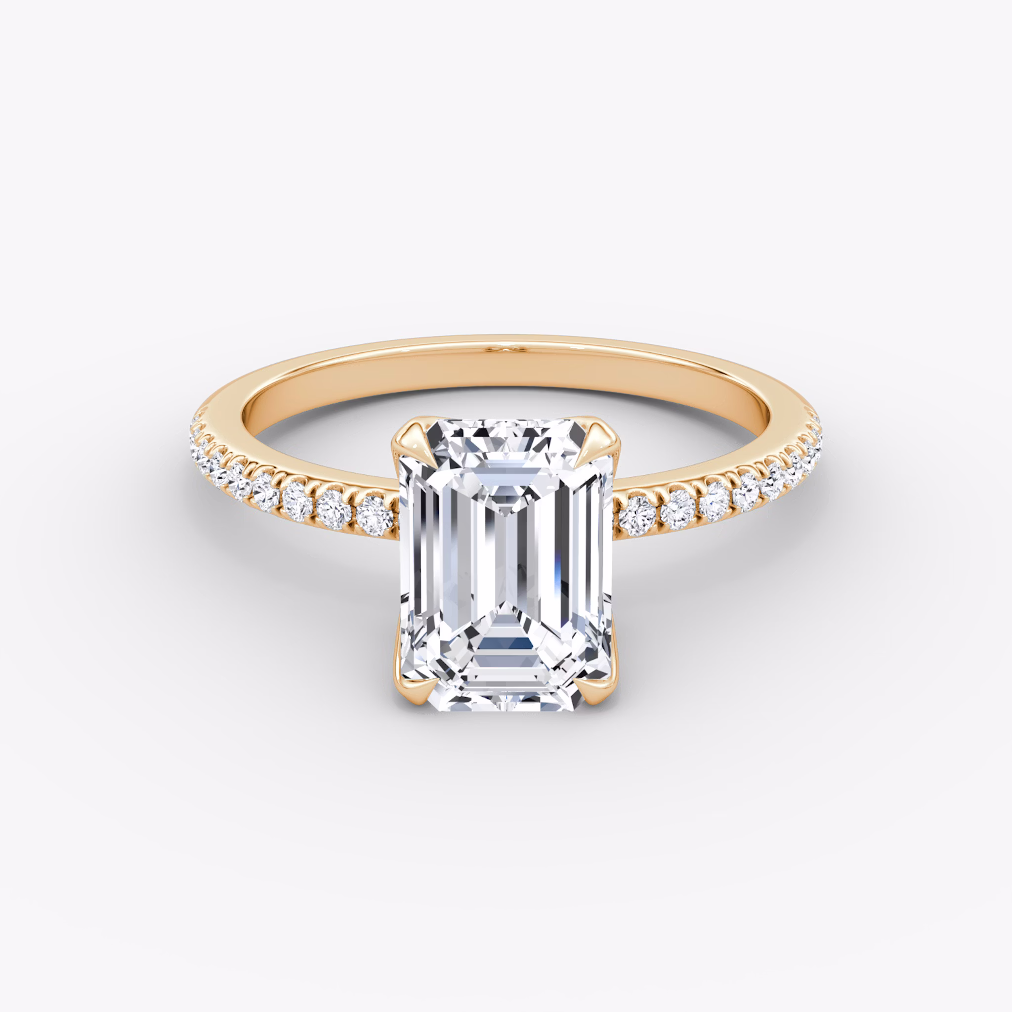 Emerald-cut diamond ring with pavé band and petal prongs in rose gold, VRAI Petal Classic setting.