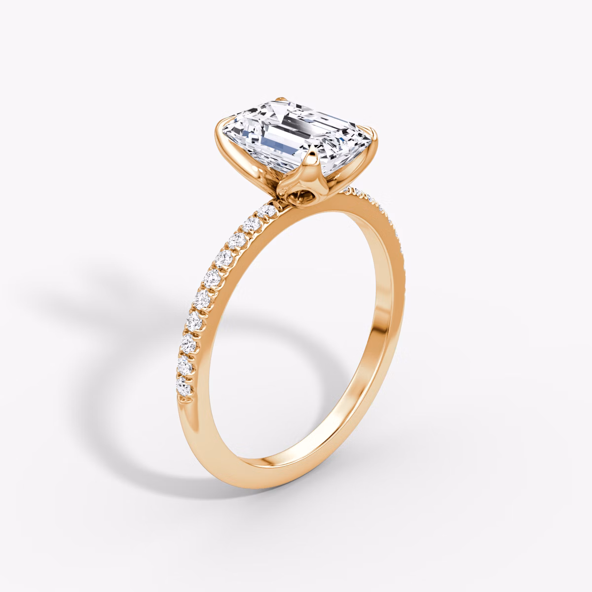 Emerald-cut diamond ring with pavé band and petal prongs in rose gold, VRAI Petal Classic setting.