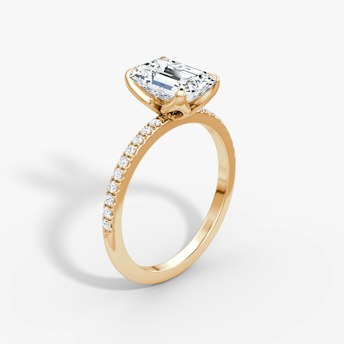 Emerald-cut diamond ring with pavé band and petal prongs in rose gold, VRAI Petal Classic setting.