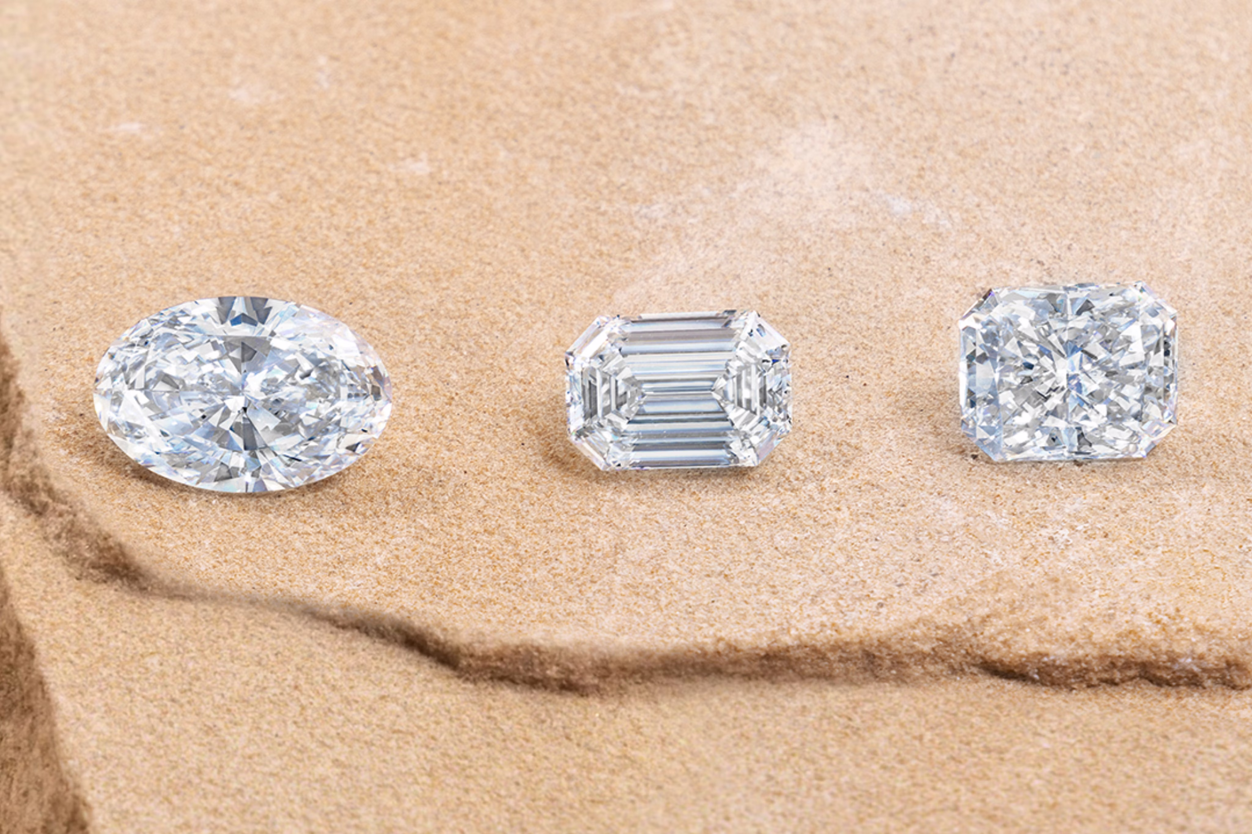 three lab grown diamonds including oval and emerald cut