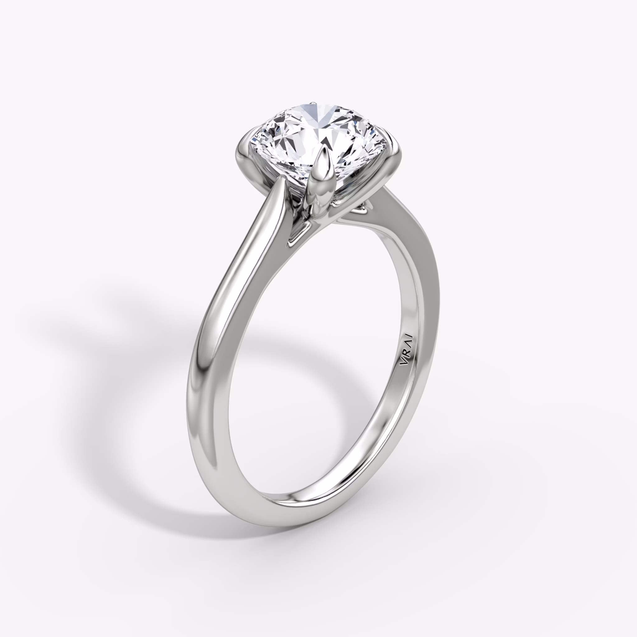 A close-up image of VRAI's Trellis Cathedral Round Brilliant White Gold Engagement Ring, standing upright.