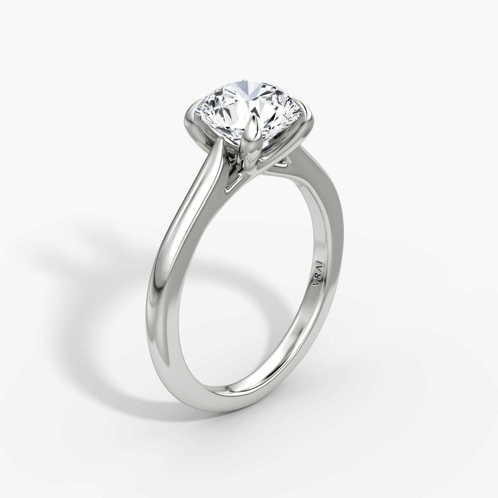 A close-up image of VRAI's Trellis Cathedral Round Brilliant White Gold Engagement Ring, standing upright.