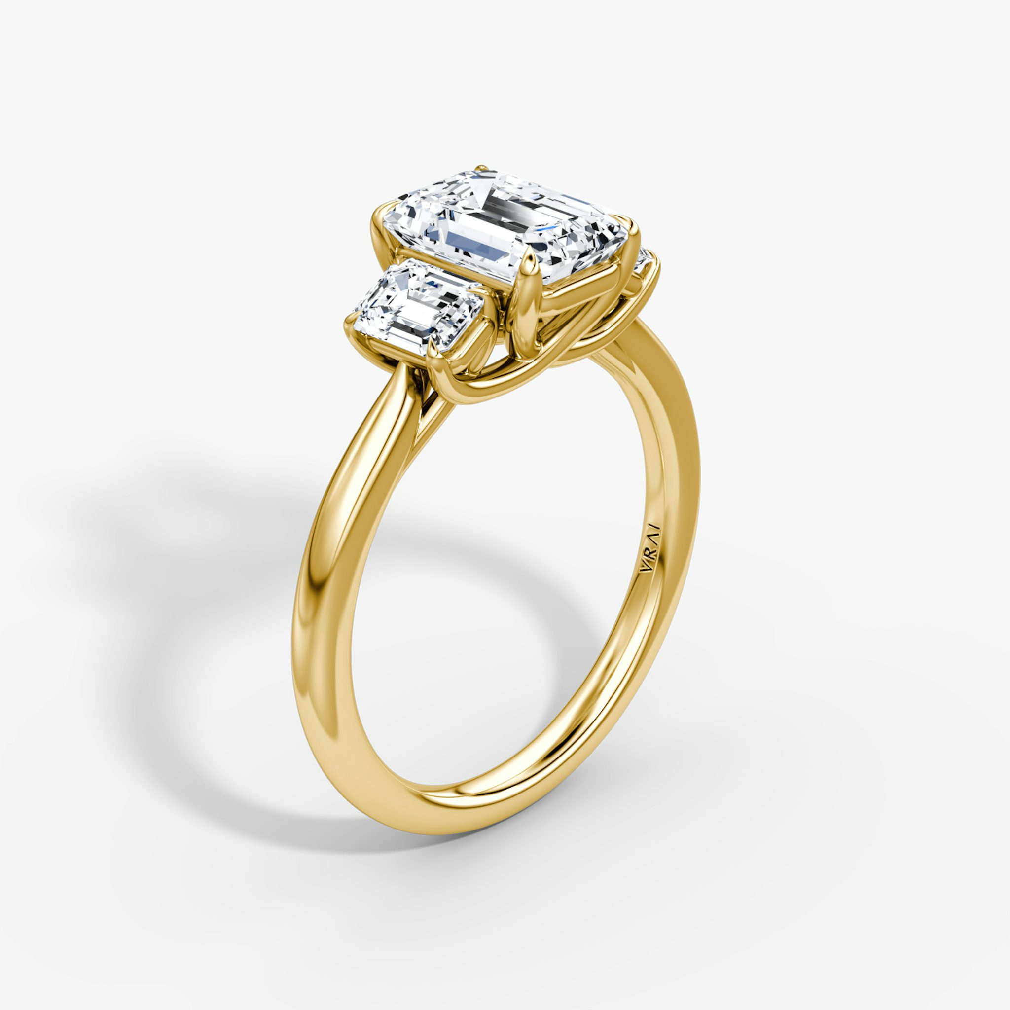 The Three Stone Emerald Yellow Gold Engagement Ring.