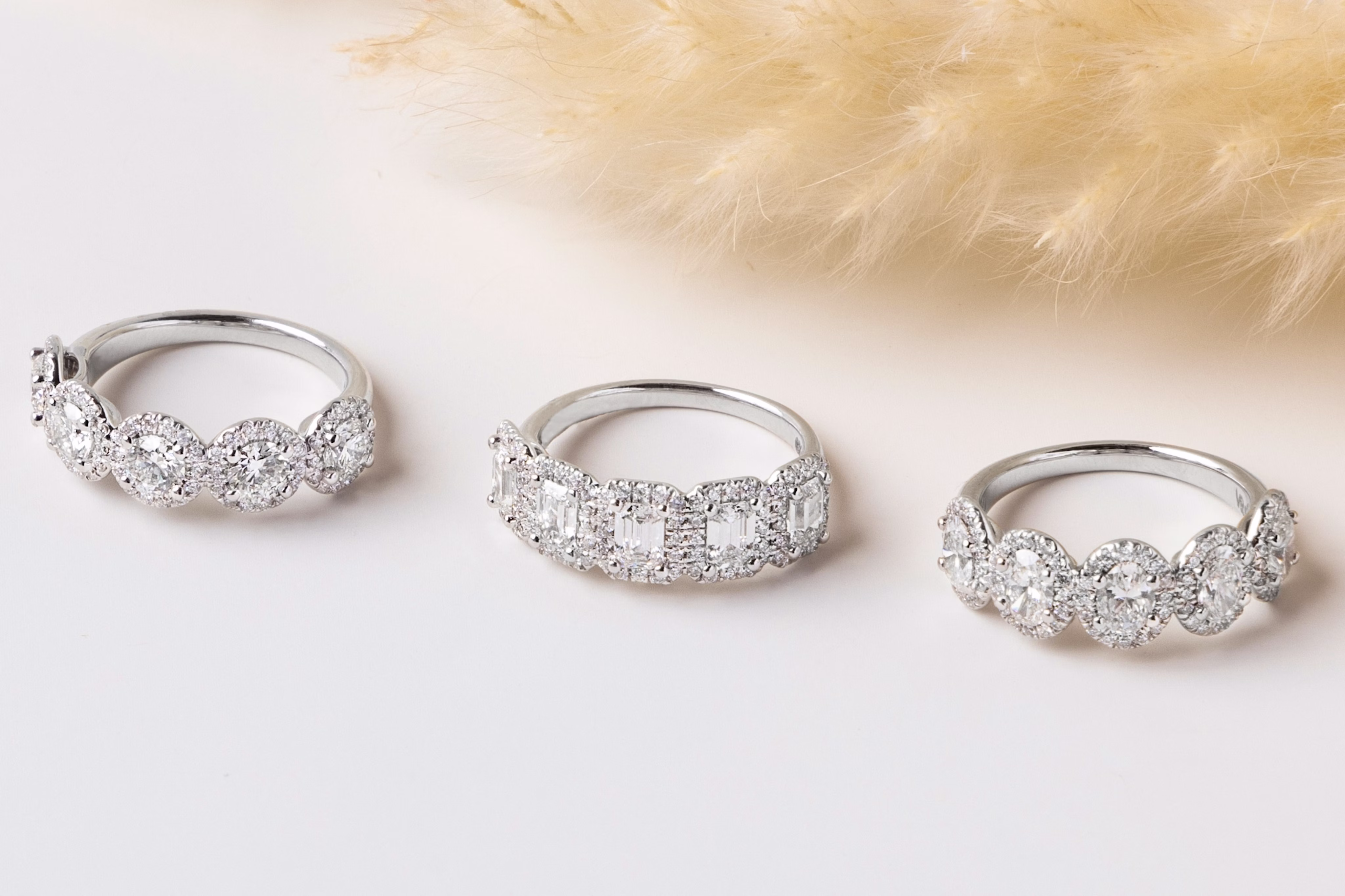 A close-up image of a person’s hand, with VRAI’s loral Cathedral Oval White Gold Engagement Ring on their ring finger.