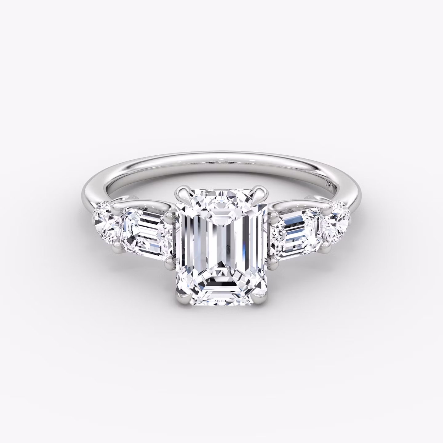 The Mixed Shape | Emerald | Platinum | bandAccent: Plain | sideStoneOrientation: horizontal | sideStoneShape: Emerald and Round Brilliant | diamondOrientation: vertical | caratWeight: other