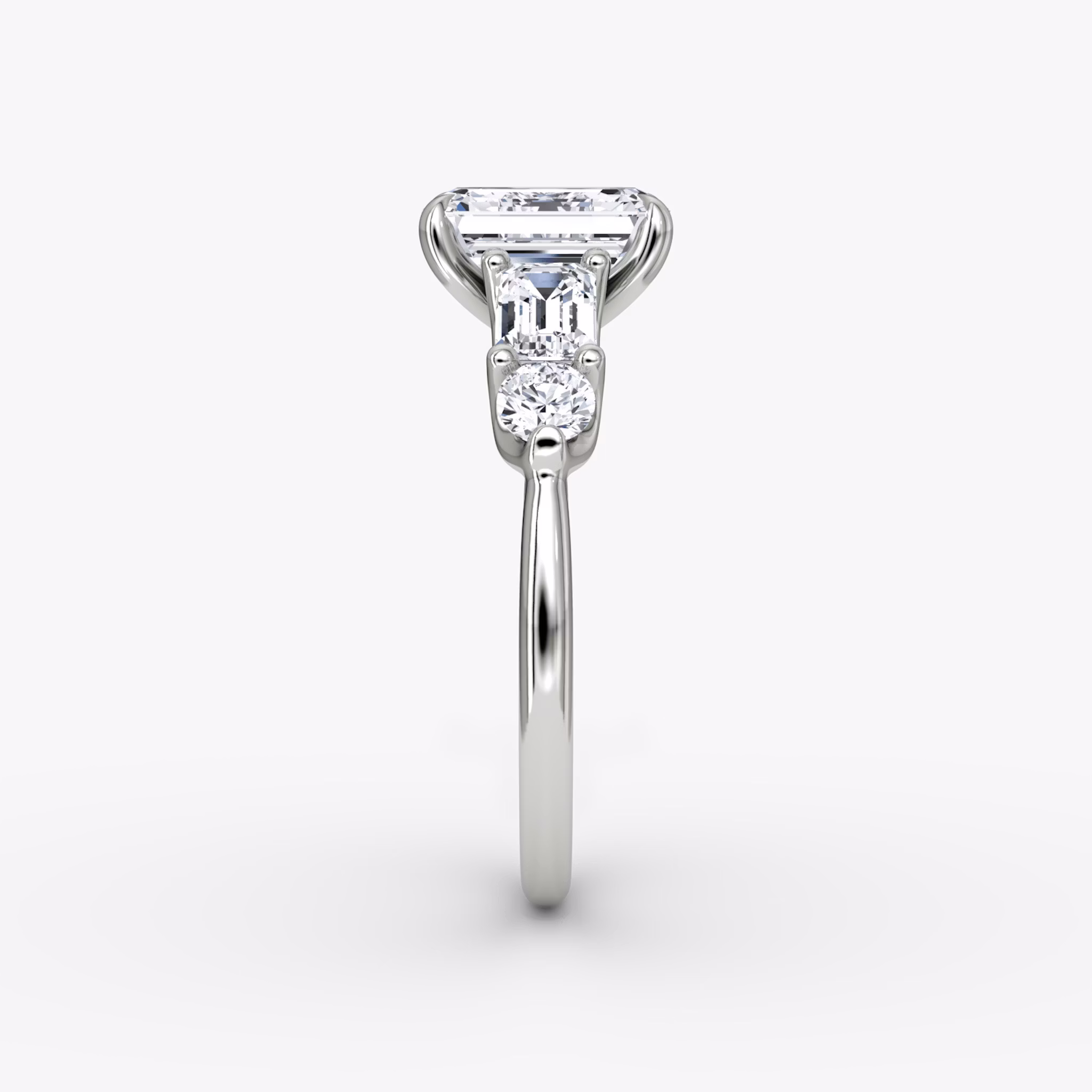 The Mixed Shape | Emerald | 18k | White Gold | bandAccent: Plain | sideStoneOrientation: horizontal | sideStoneShape: Emerald and Round Brilliant | diamondOrientation: vertical | caratWeight: other