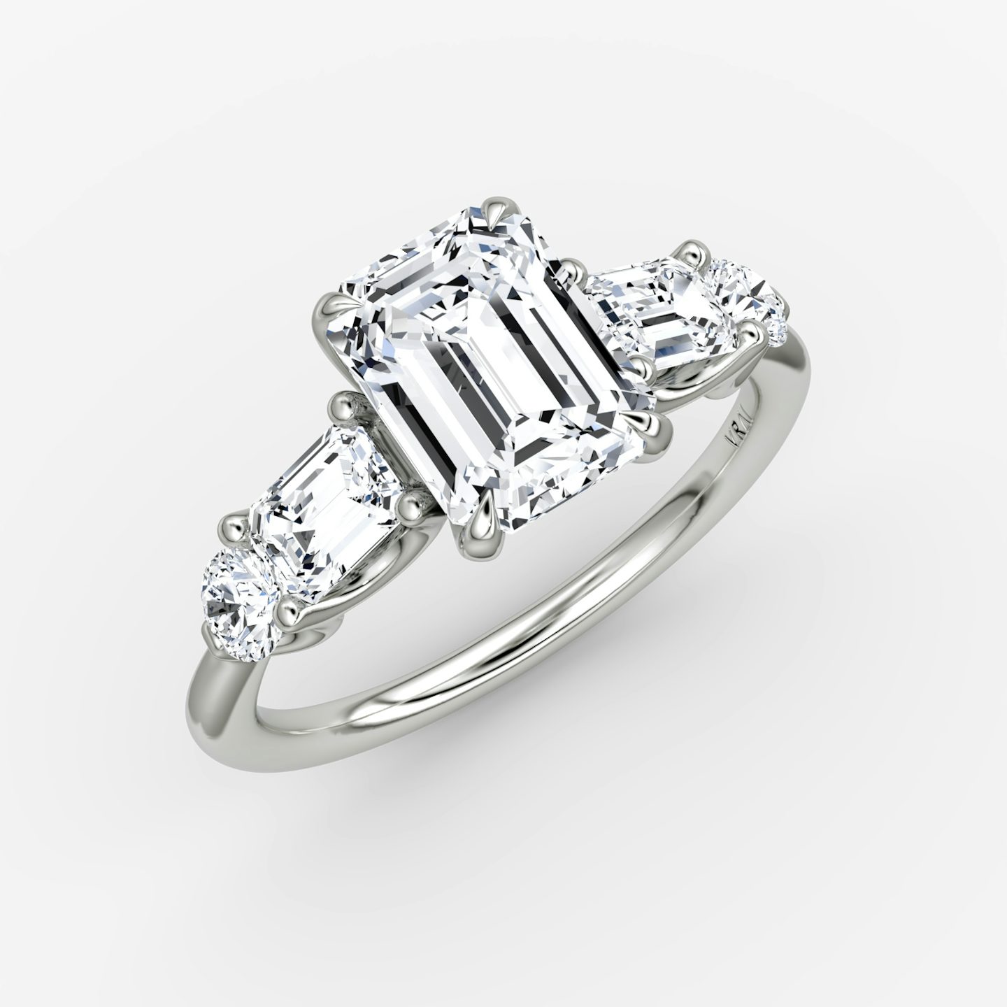 The Mixed Shape | Emerald | Platinum | bandAccent: Plain | sideStoneOrientation: horizontal | sideStoneShape: Emerald and Round Brilliant | diamondOrientation: vertical | caratWeight: other