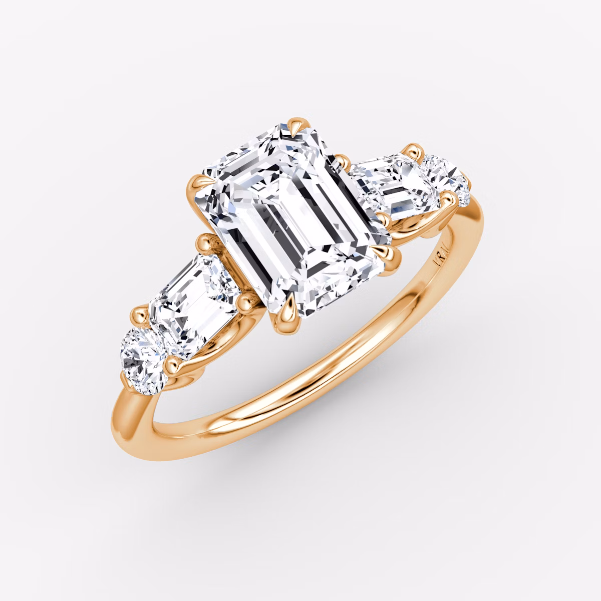 The Mixed Shape | Emerald | 14k | Rose Gold | bandAccent: Plain | sideStoneOrientation: horizontal | sideStoneShape: Emerald and Round Brilliant | diamondOrientation: vertical | caratWeight: other