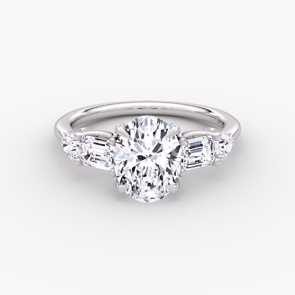 The Mixed Shape | Oval | Platinum | bandAccent: Plain | sideStoneOrientation: horizontal | sideStoneShape: Emerald and Round Brilliant | diamondOrientation: vertical | caratWeight: other