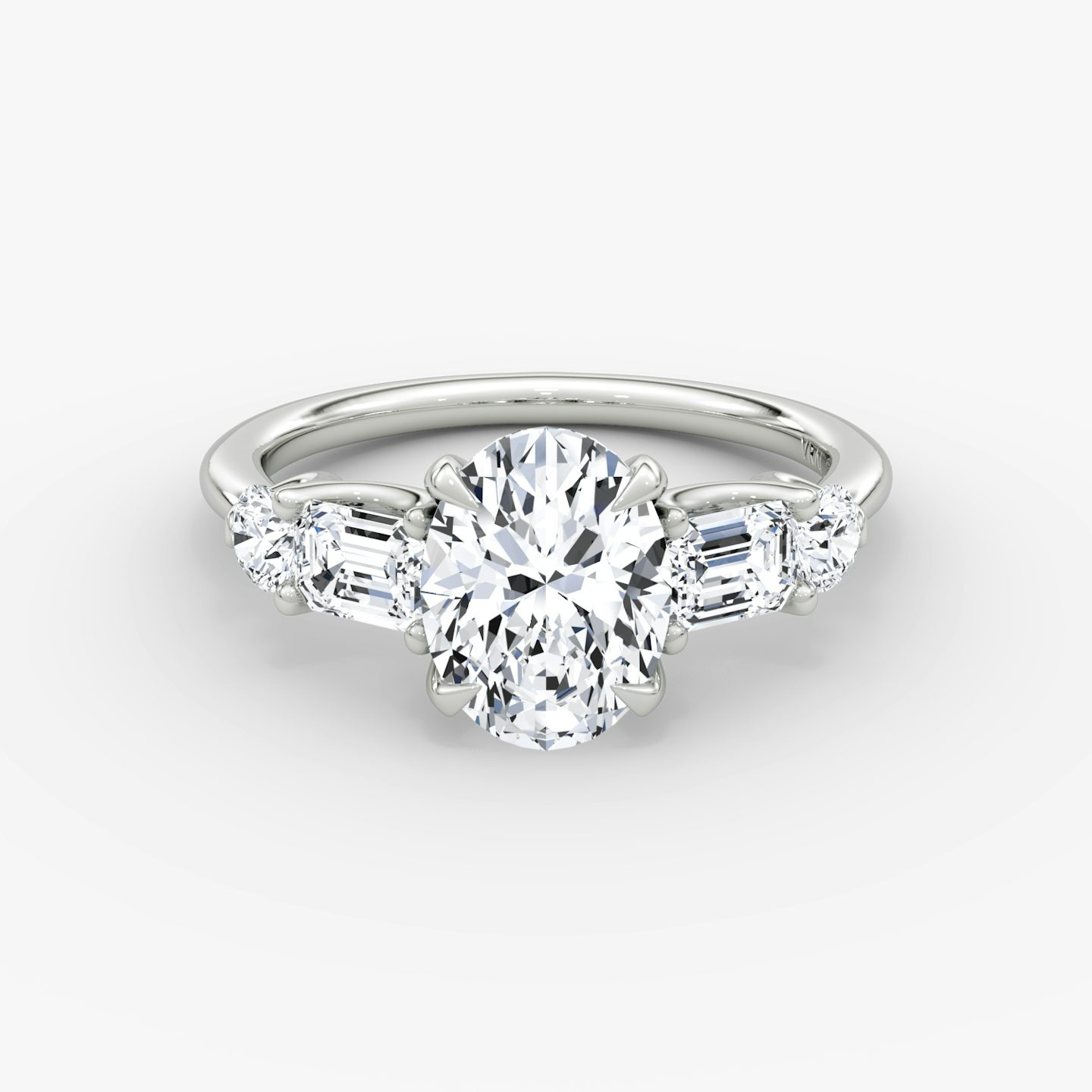 The Mixed Shape | Oval | Platinum | bandAccent: Plain | sideStoneOrientation: horizontal | sideStoneShape: Emerald and Round Brilliant | diamondOrientation: vertical | caratWeight: other
