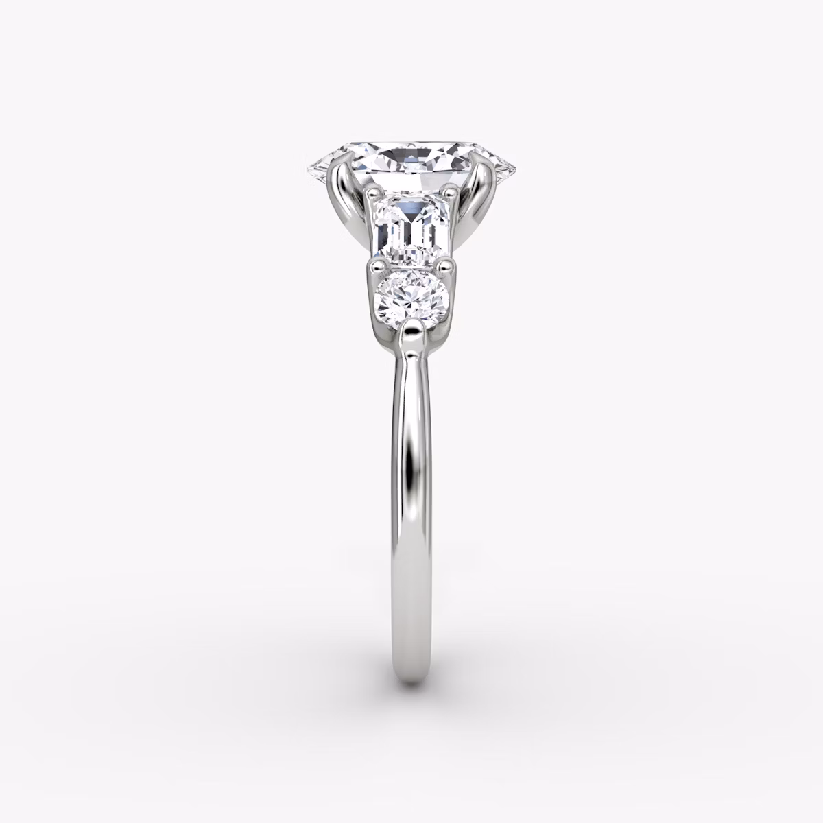 The Mixed Shape | Oval | Platinum | bandAccent: Plain | sideStoneOrientation: horizontal | sideStoneShape: Emerald and Round Brilliant | diamondOrientation: vertical | caratWeight: other