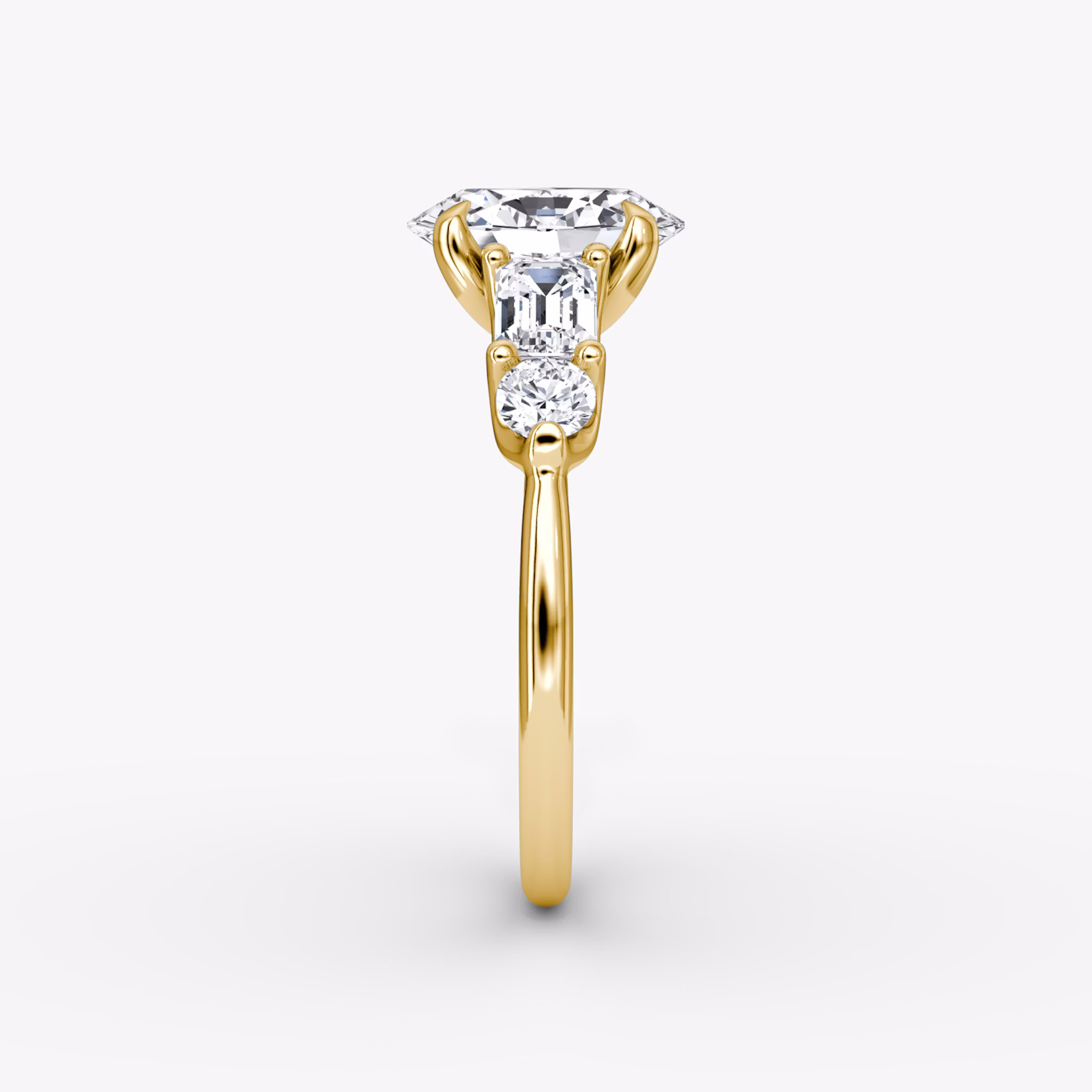 The Mixed Shape | Oval | 18k | Yellow Gold | bandAccent: Plain | sideStoneOrientation: horizontal | sideStoneShape: Emerald and Round Brilliant | diamondOrientation: vertical | caratWeight: other