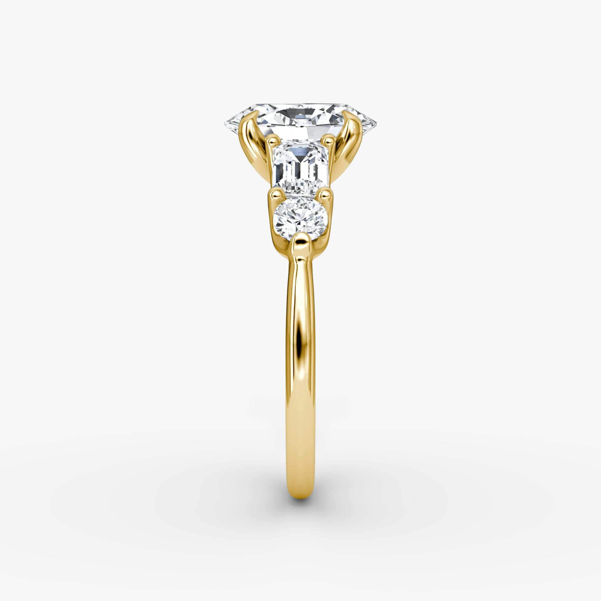 The Mixed Shape | Oval | 18k | Yellow Gold | bandAccent: Plain | sideStoneOrientation: horizontal | sideStoneShape: Emerald and Round Brilliant | diamondOrientation: vertical | caratWeight: other