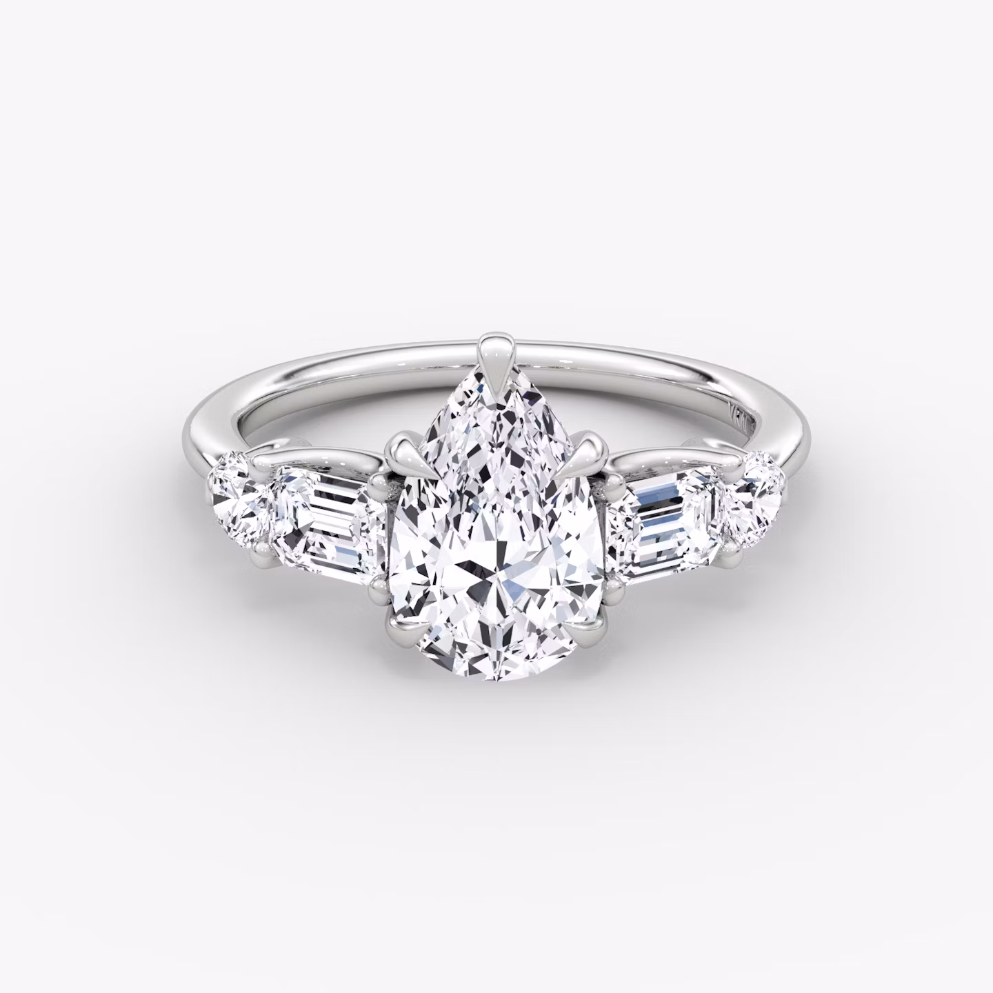 The Mixed Shape | Pear | Platinum | bandAccent: Plain | sideStoneOrientation: horizontal | sideStoneShape: Emerald and Round Brilliant | diamondOrientation: vertical | caratWeight: other