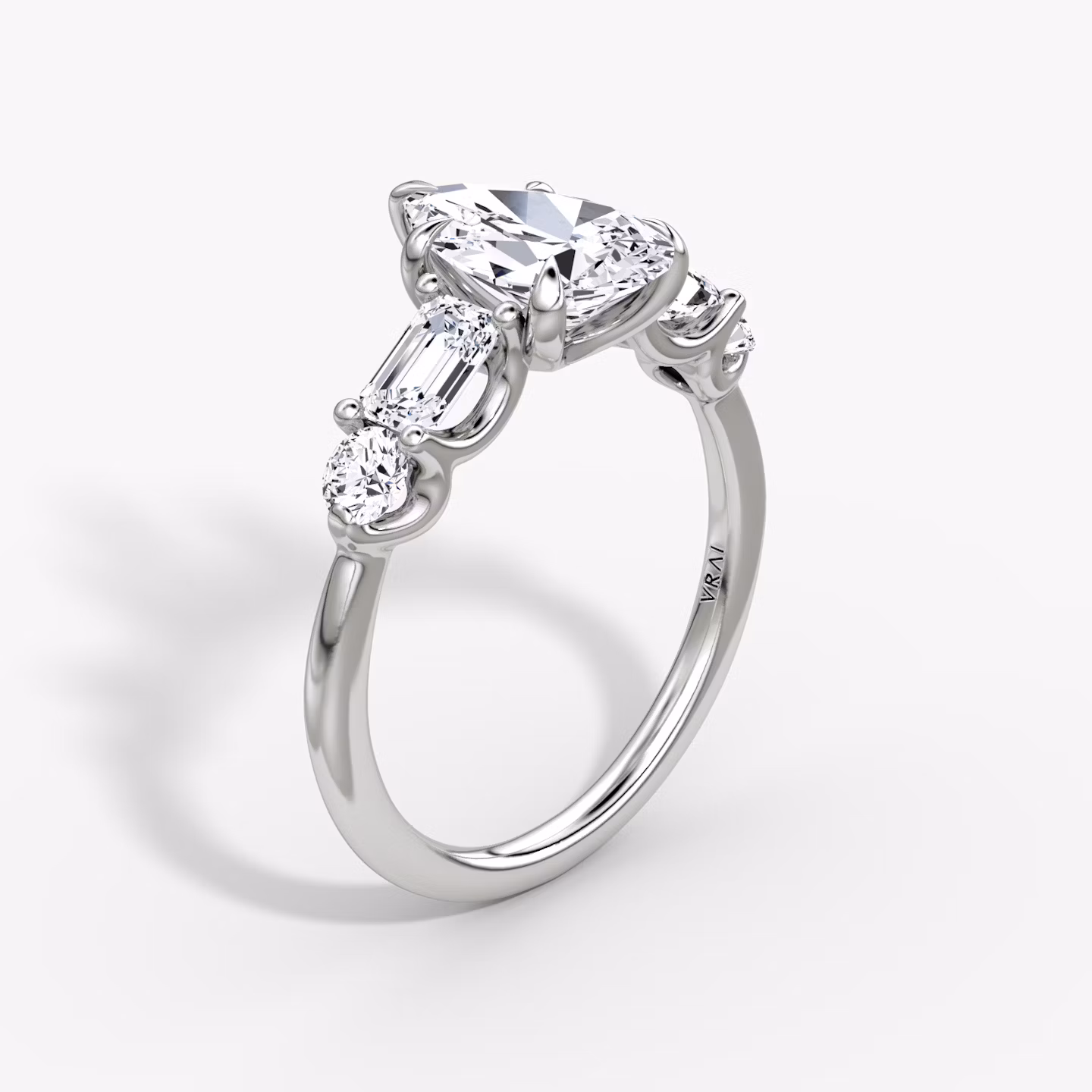 The Mixed Shape | Pear | Platinum | bandAccent: Plain | sideStoneOrientation: horizontal | sideStoneShape: Emerald and Round Brilliant | diamondOrientation: vertical | caratWeight: other