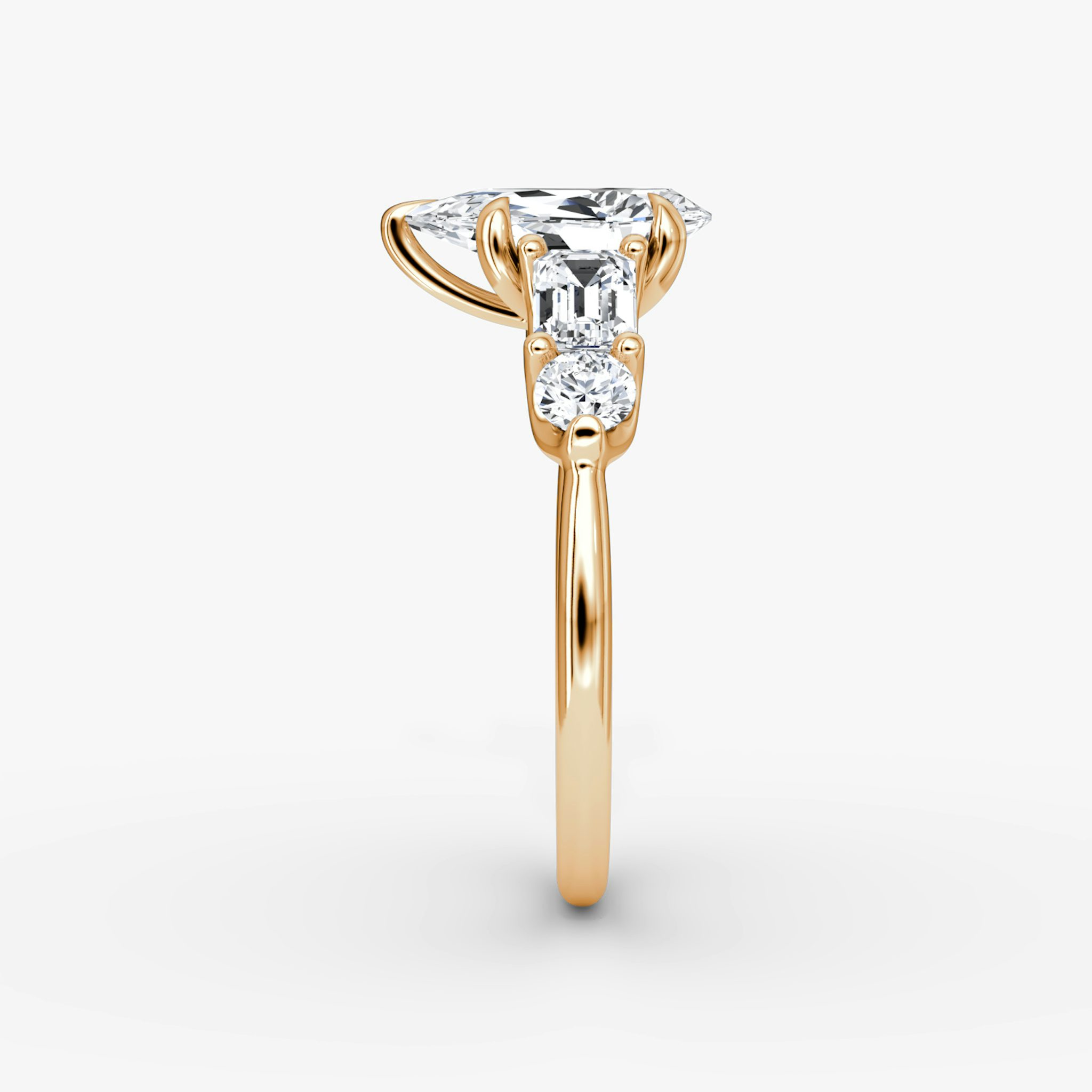 The Mixed Shape | Pear | 14k | Rose Gold | bandAccent: Plain | sideStoneOrientation: horizontal | sideStoneShape: Emerald and Round Brilliant | diamondOrientation: vertical | caratWeight: other