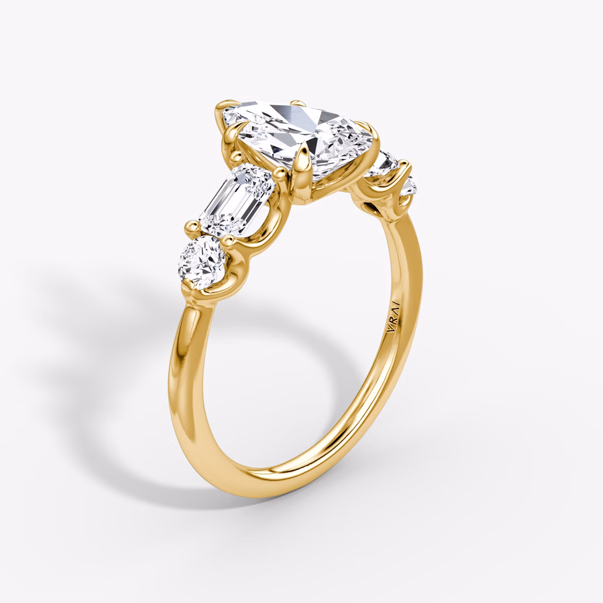 The Mixed Shape | Pear | 18k | Yellow Gold | bandAccent: Plain | sideStoneOrientation: horizontal | sideStoneShape: Emerald and Round Brilliant | diamondOrientation: vertical | caratWeight: other