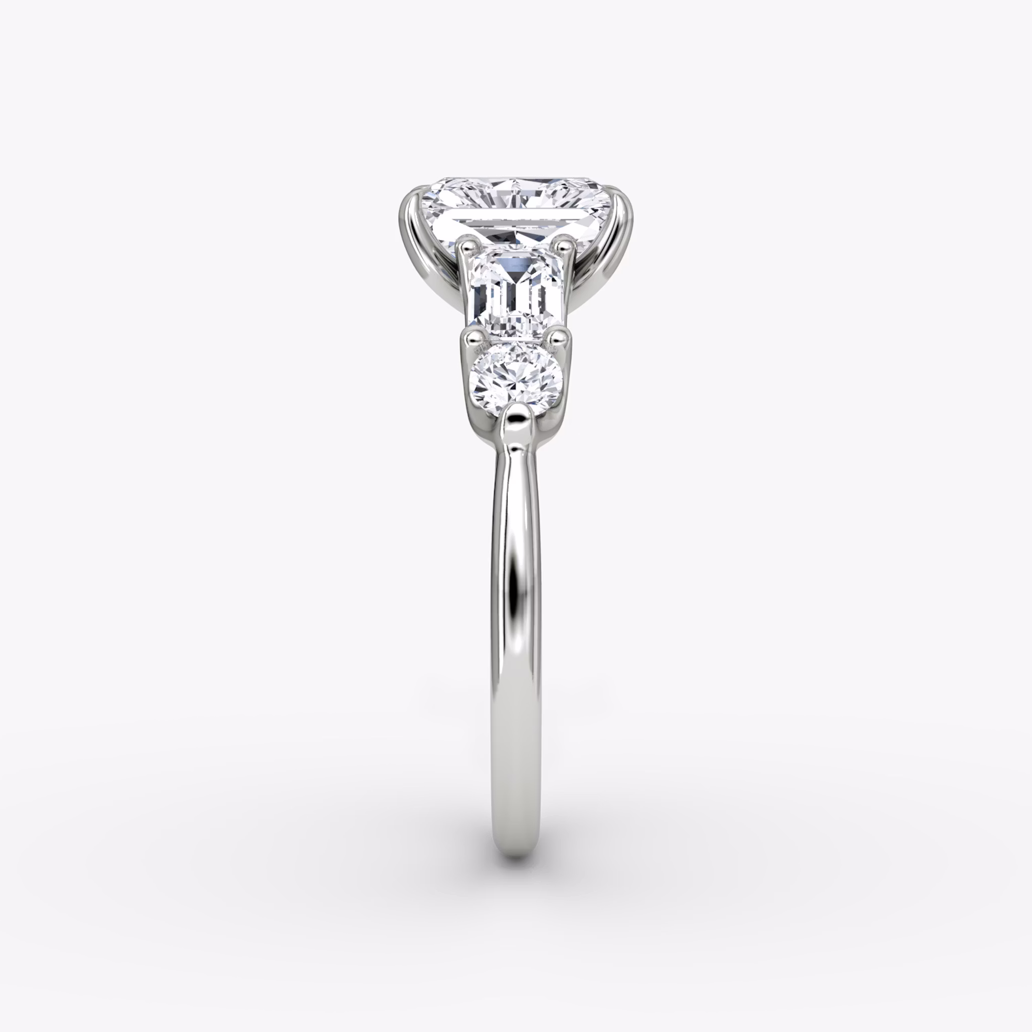 The Mixed Shape | Radiant | 18k | White Gold | bandAccent: Plain | sideStoneOrientation: horizontal | sideStoneShape: Emerald and Round Brilliant | diamondOrientation: vertical | caratWeight: other