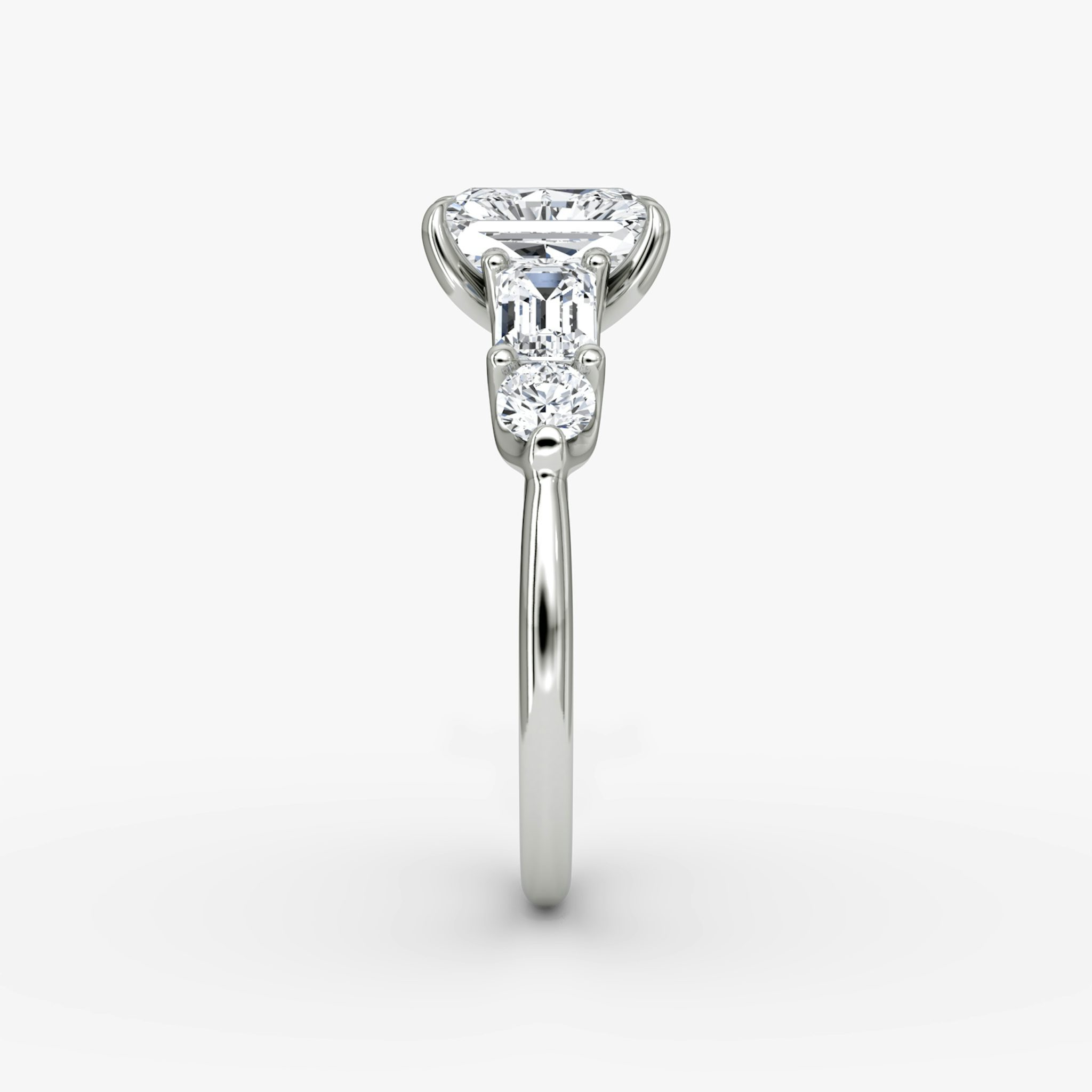 The Mixed Shape | Radiant | 18k | White Gold | bandAccent: Plain | sideStoneOrientation: horizontal | sideStoneShape: Emerald and Round Brilliant | diamondOrientation: vertical | caratWeight: other