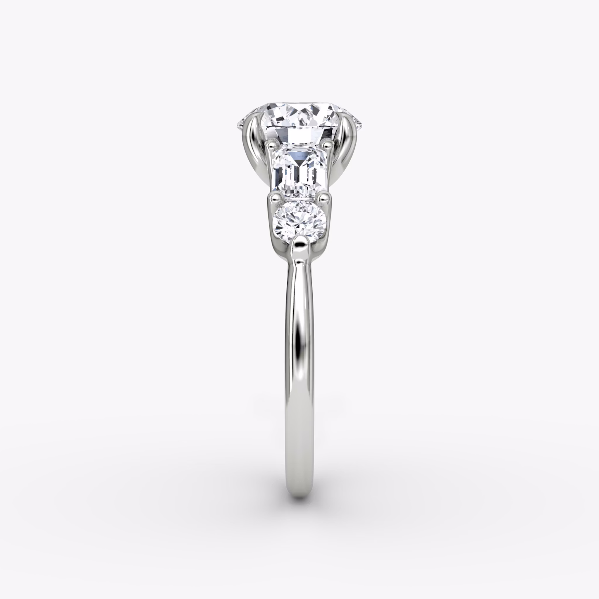 The Mixed Shape | Round Brilliant | 18k | White Gold | bandAccent: Plain | caratWeight: other | sideStoneOrientation: horizontal | sideStoneShape: Emerald and Round Brilliant | diamondOrientation: vertical