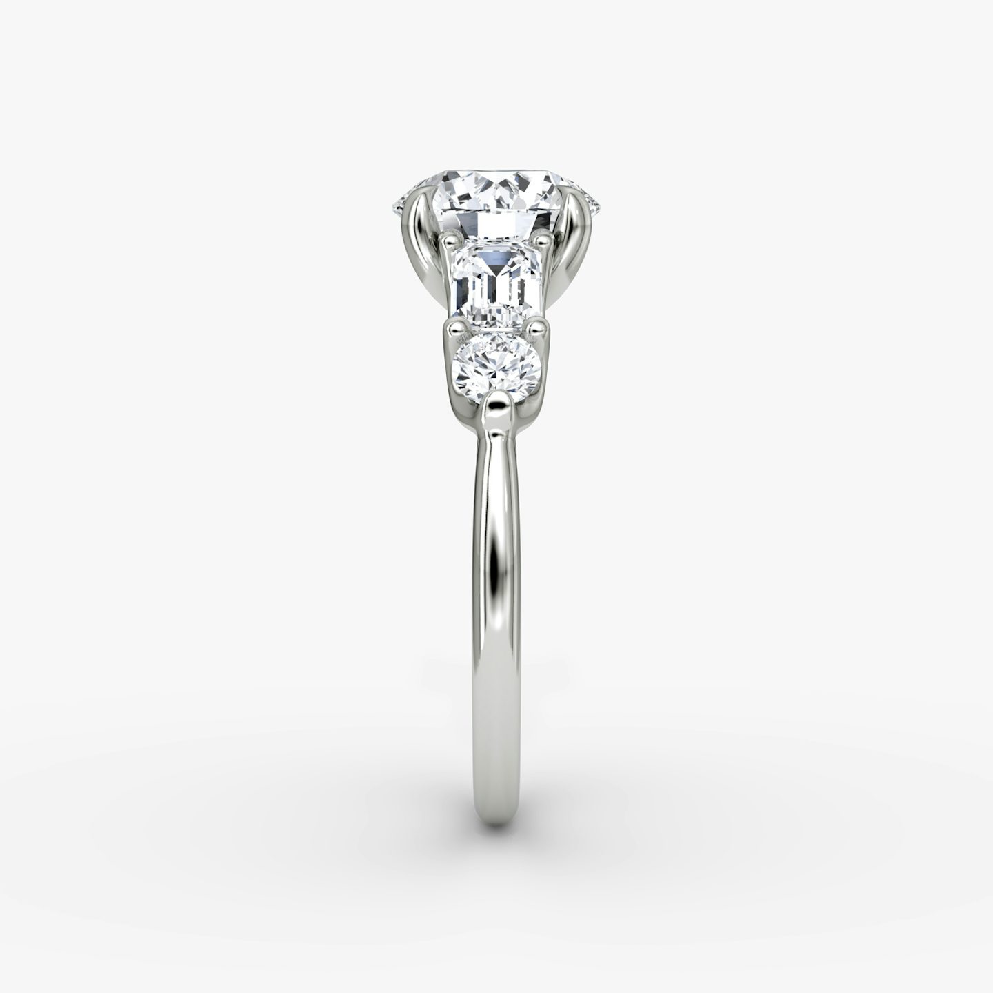 The Mixed Shape | Round Brilliant | Platinum | bandAccent: Plain | caratWeight: other | sideStoneOrientation: horizontal | sideStoneShape: Emerald and Round Brilliant | diamondOrientation: vertical