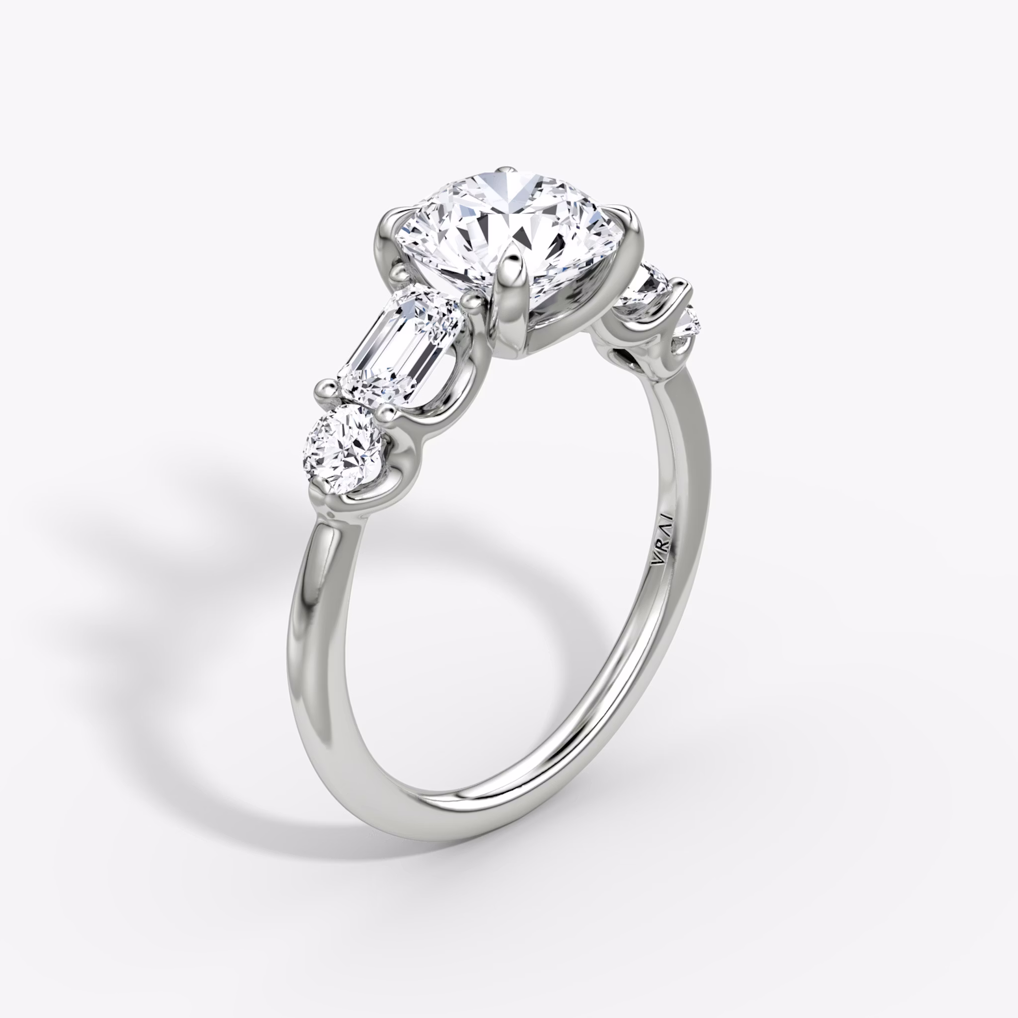 The Mixed Shape | Round Brilliant | 18k | White Gold | bandAccent: Plain | caratWeight: other | sideStoneOrientation: horizontal | sideStoneShape: Emerald and Round Brilliant | diamondOrientation: vertical