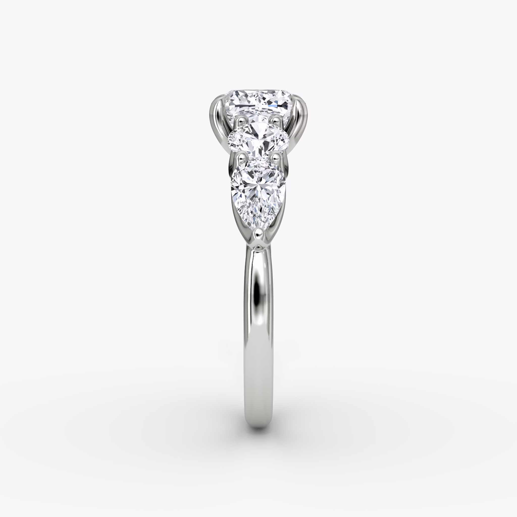 The Mixed Shape | Cushion | 18k | White Gold | bandAccent: Plain | sideStoneOrientation: horizontal | sideStoneShape: Round Brilliant and Pear | diamondOrientation: vertical | caratWeight: other