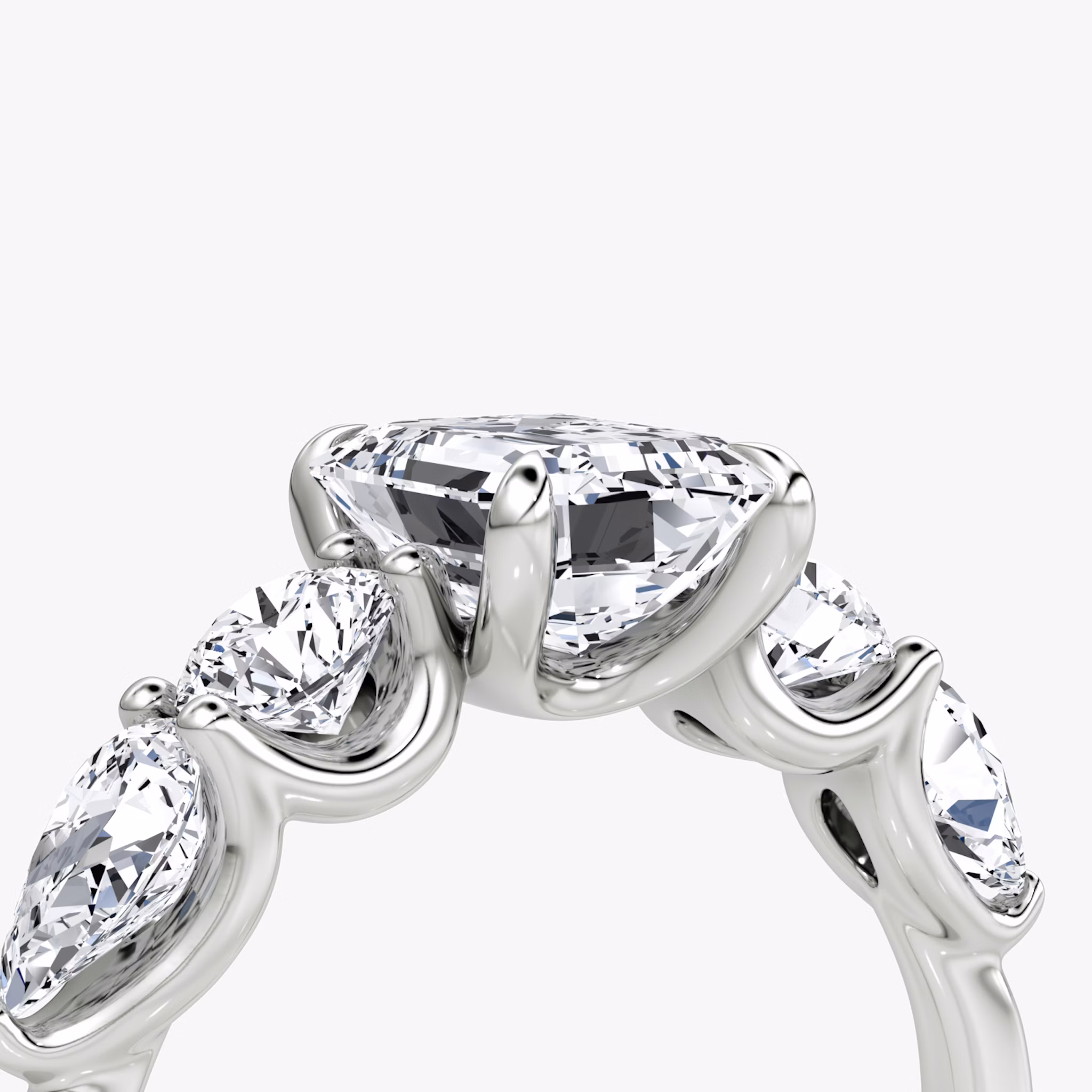 The Mixed Shape | Emerald | 18k | White Gold | bandAccent: Plain | sideStoneOrientation: horizontal | sideStoneShape: Round Brilliant and Pear | diamondOrientation: vertical | caratWeight: other