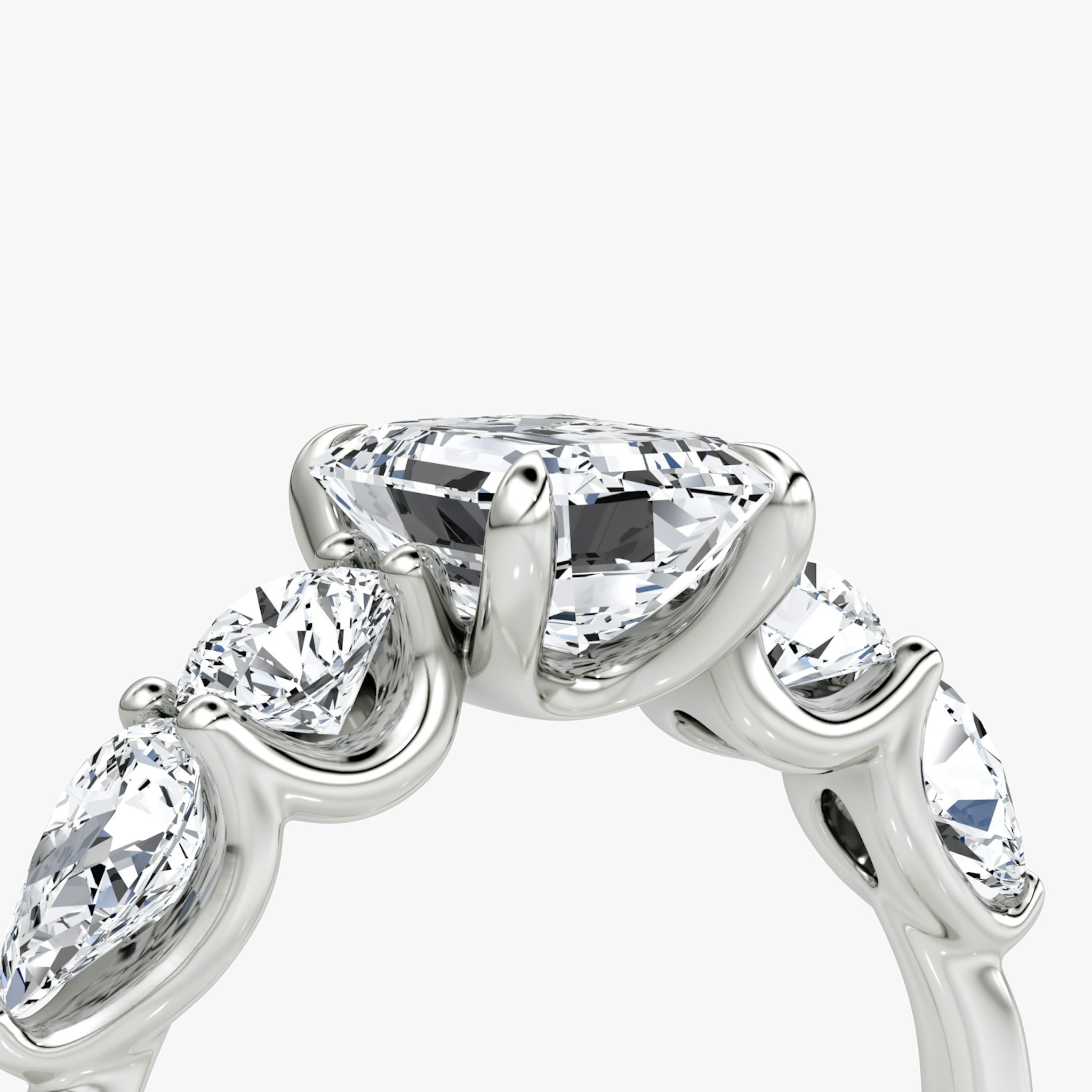 The Mixed Shape | Emerald | 18k | White Gold | bandAccent: Plain | sideStoneOrientation: horizontal | sideStoneShape: Round Brilliant and Pear | diamondOrientation: vertical | caratWeight: other