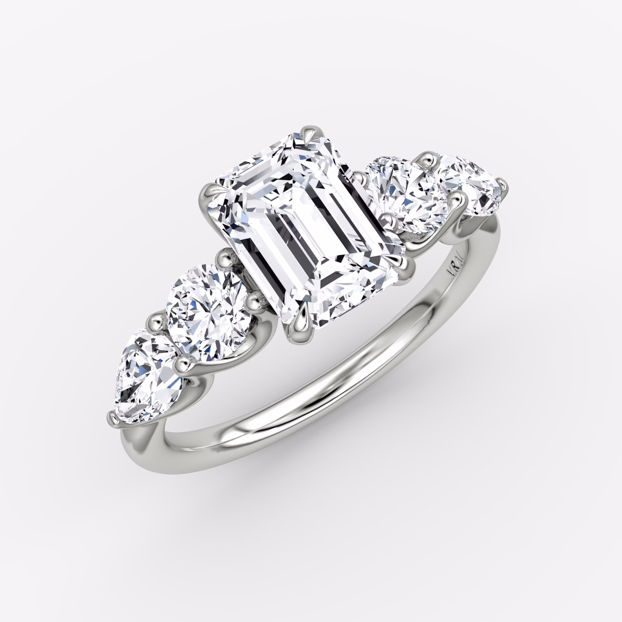 The Mixed Shape | Emerald | 18k | White Gold | bandAccent: Plain | sideStoneOrientation: horizontal | sideStoneShape: Round Brilliant and Pear | diamondOrientation: vertical | caratWeight: other