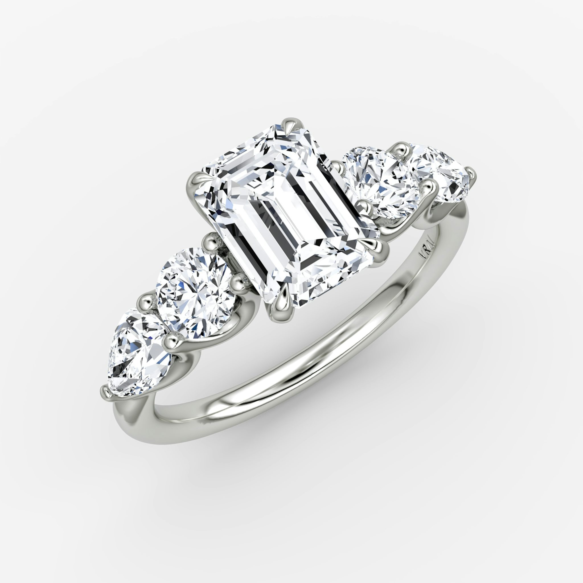 The Mixed Shape | Emerald | 18k | White Gold | bandAccent: Plain | sideStoneOrientation: horizontal | sideStoneShape: Round Brilliant and Pear | diamondOrientation: vertical | caratWeight: other