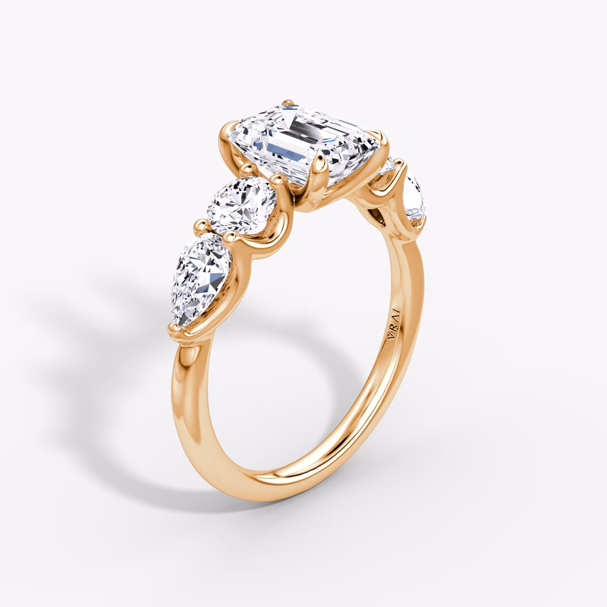 The Mixed Shape | Emerald | 14k | Rose Gold | bandAccent: Plain | sideStoneOrientation: horizontal | sideStoneShape: Round Brilliant and Pear | diamondOrientation: vertical | caratWeight: other