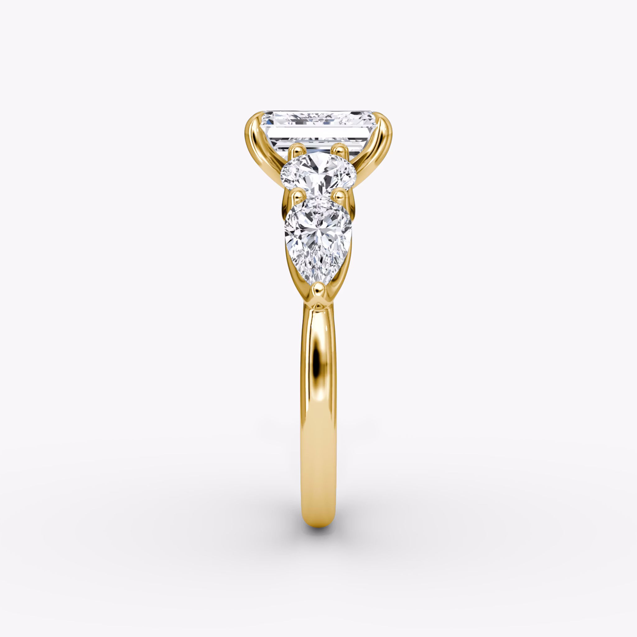 The Mixed Shape | Emerald | 18k | Yellow Gold | bandAccent: Plain | sideStoneOrientation: horizontal | sideStoneShape: Round Brilliant and Pear | diamondOrientation: vertical | caratWeight: other