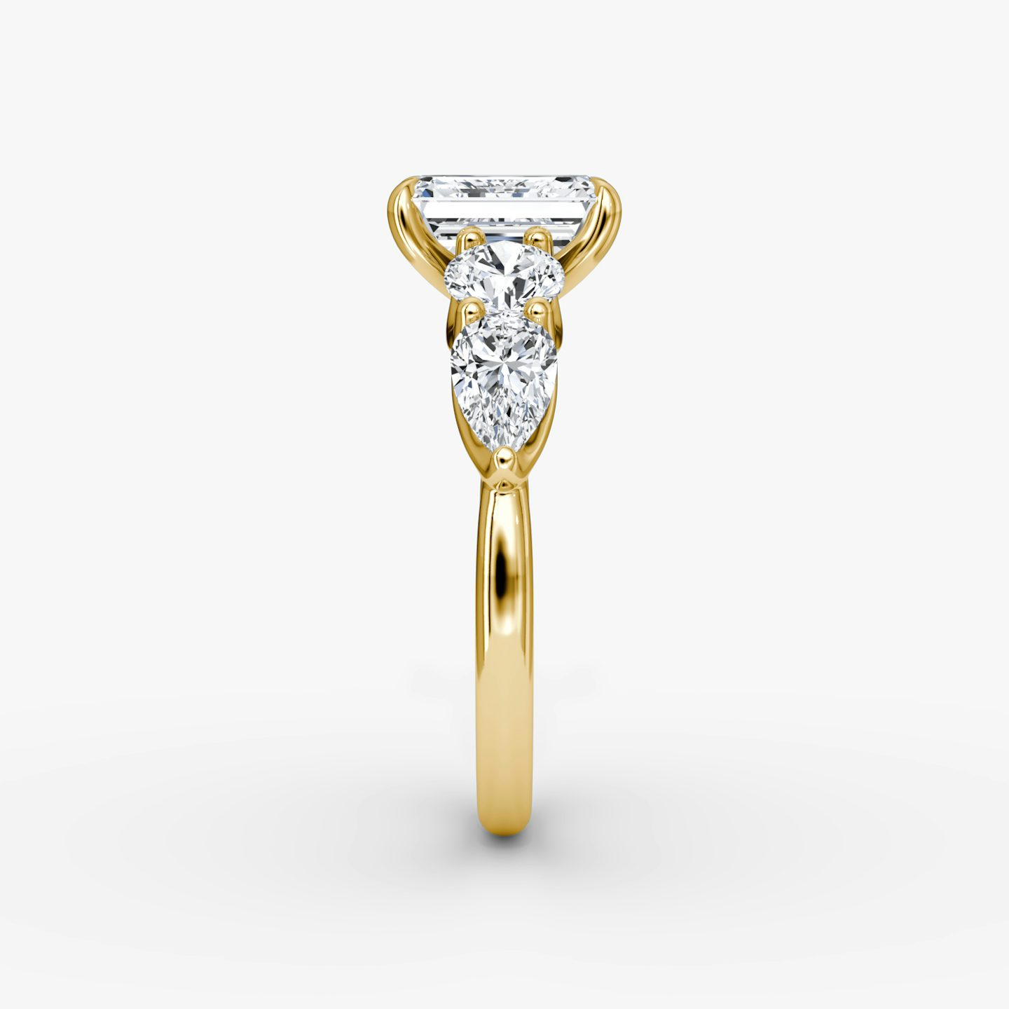 The Mixed Shape | Emerald | 18k | Yellow Gold | bandAccent: Plain | sideStoneOrientation: horizontal | sideStoneShape: Round Brilliant and Pear | diamondOrientation: vertical | caratWeight: other
