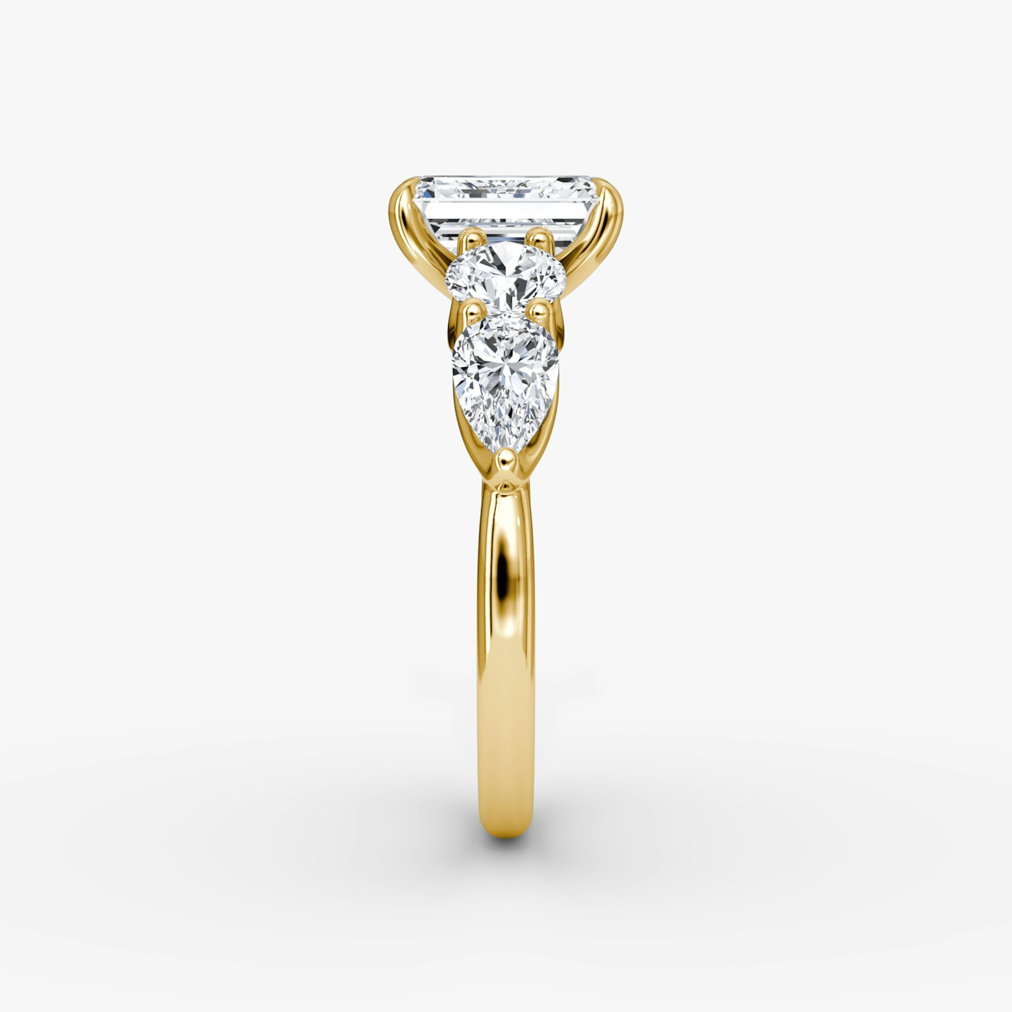 The Mixed Shape | Emerald | 18k | Yellow Gold | bandAccent: Plain | sideStoneOrientation: horizontal | sideStoneShape: Round Brilliant and Pear | diamondOrientation: vertical | caratWeight: other