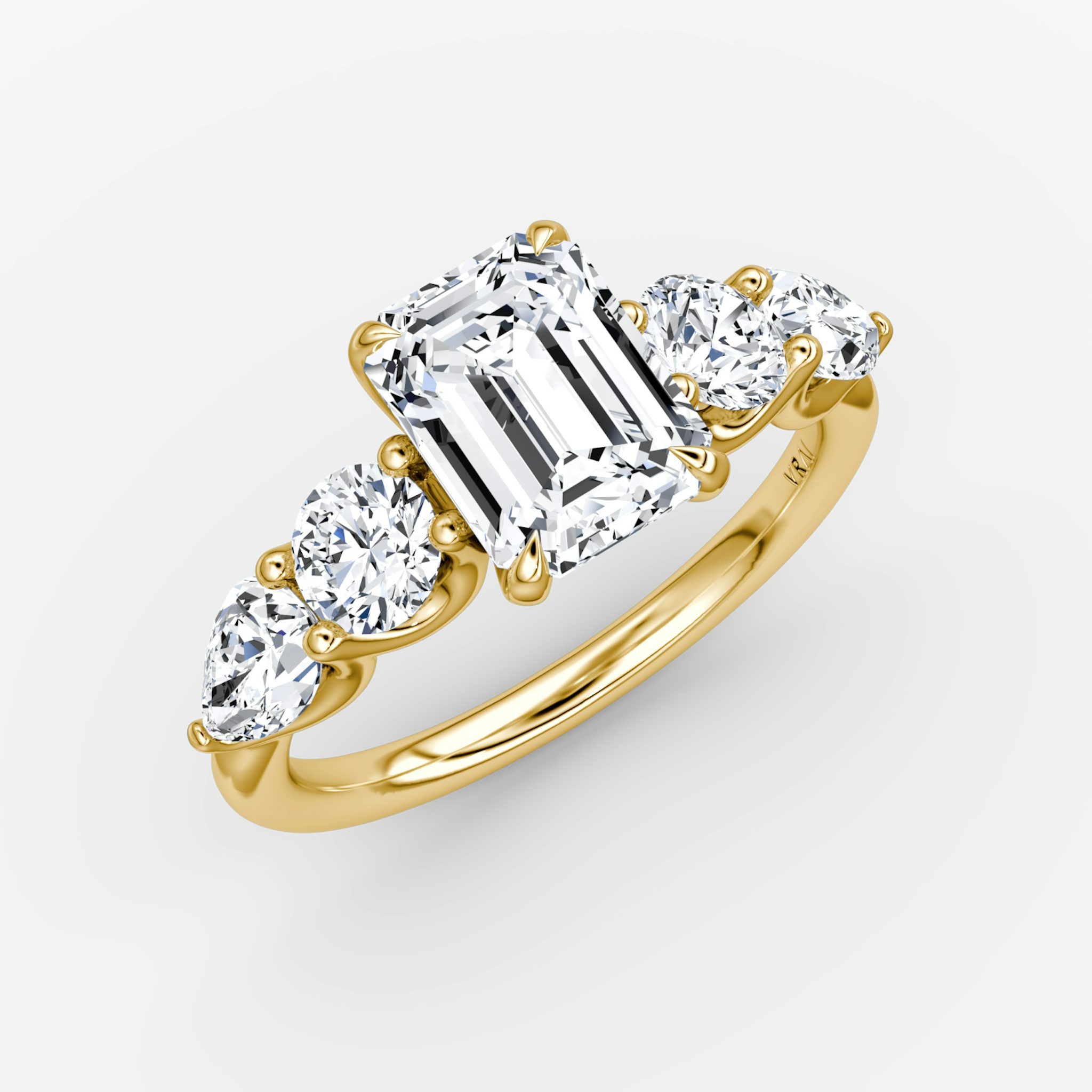 The Mixed Shape | Emerald | 18k | Yellow Gold | bandAccent: Plain | sideStoneOrientation: horizontal | sideStoneShape: Round Brilliant and Pear | diamondOrientation: vertical | caratWeight: other