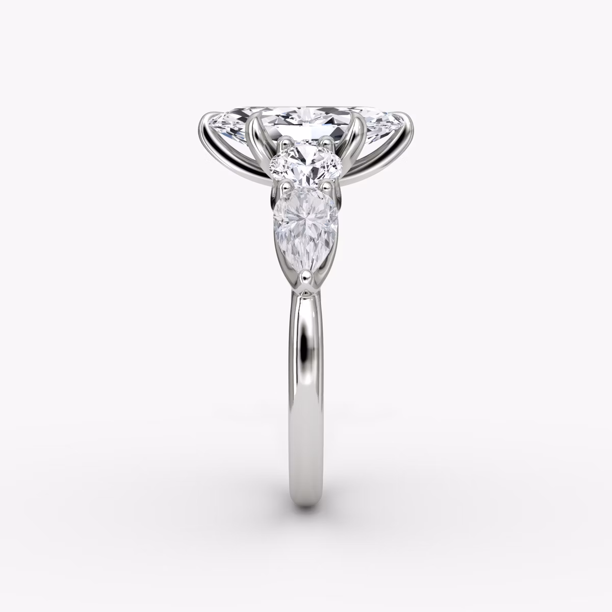 The Mixed Shape | Marquise | Platinum | bandAccent: Plain | sideStoneOrientation: horizontal | sideStoneShape: Round Brilliant and Pear | diamondOrientation: vertical | caratWeight: other