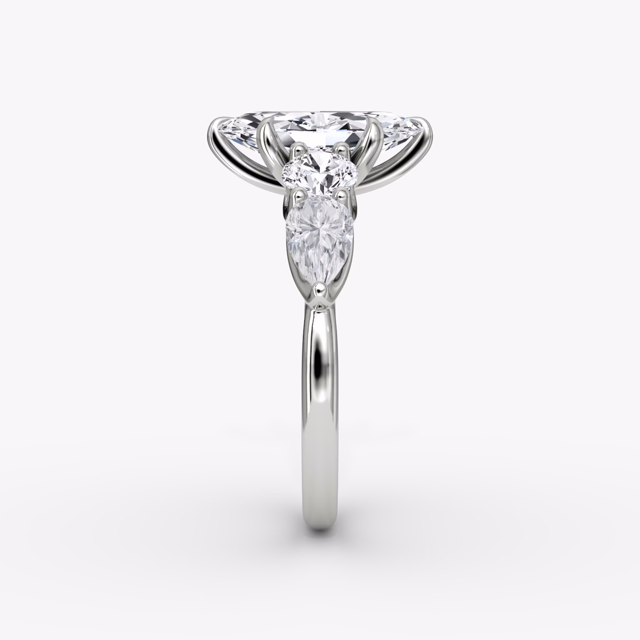 The Mixed Shape | Marquise | 18k | White Gold | bandAccent: Plain | sideStoneOrientation: horizontal | sideStoneShape: Round Brilliant and Pear | diamondOrientation: vertical | caratWeight: other