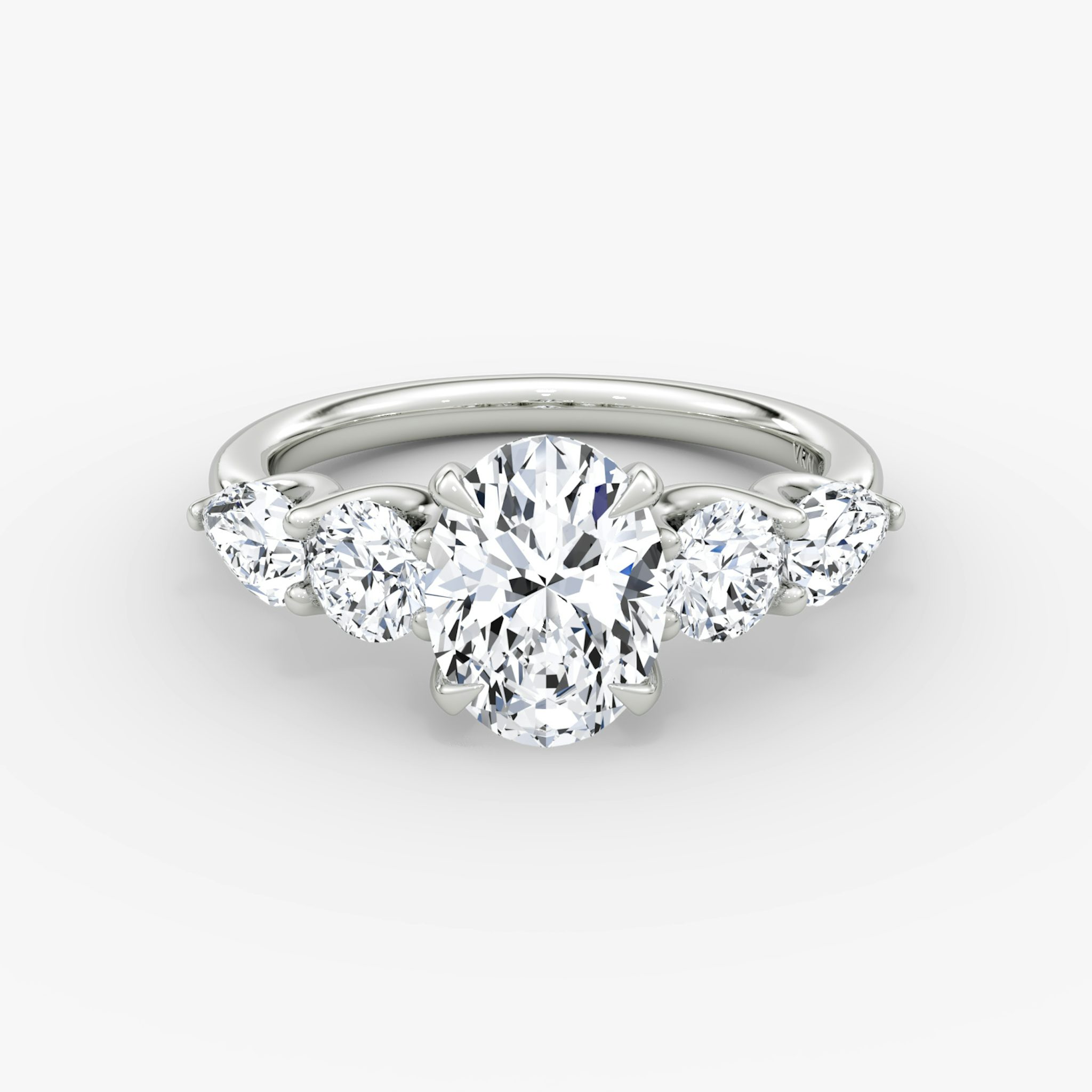 The Mixed Shape | Oval | 18k | White Gold | bandAccent: Plain | sideStoneOrientation: horizontal | sideStoneShape: Round Brilliant and Pear | diamondOrientation: vertical | caratWeight: other
