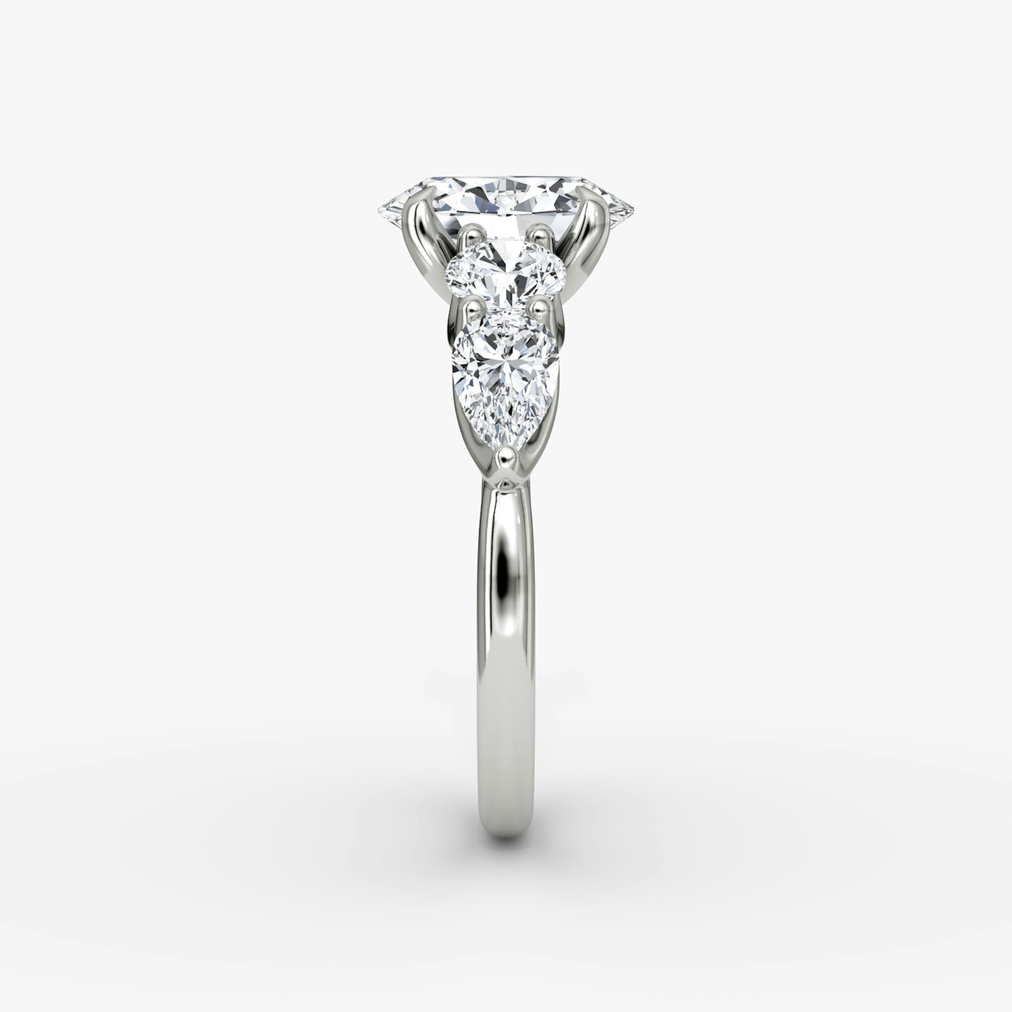 The Mixed Shape | Oval | 18k | White Gold | bandAccent: Plain | sideStoneOrientation: horizontal | sideStoneShape: Round Brilliant and Pear | diamondOrientation: vertical | caratWeight: other