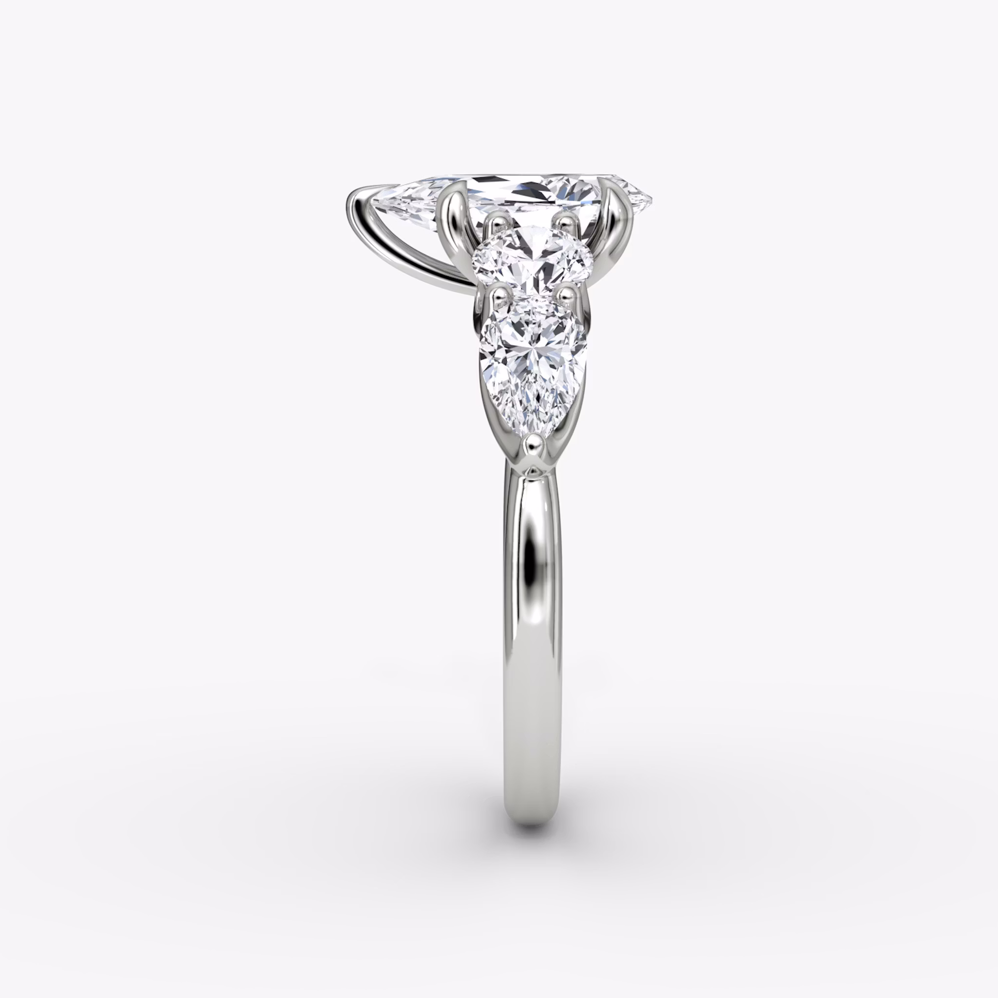 The Mixed Shape | Pear | 18k | White Gold | bandAccent: Plain | sideStoneOrientation: horizontal | sideStoneShape: Round Brilliant and Pear | diamondOrientation: vertical | caratWeight: other