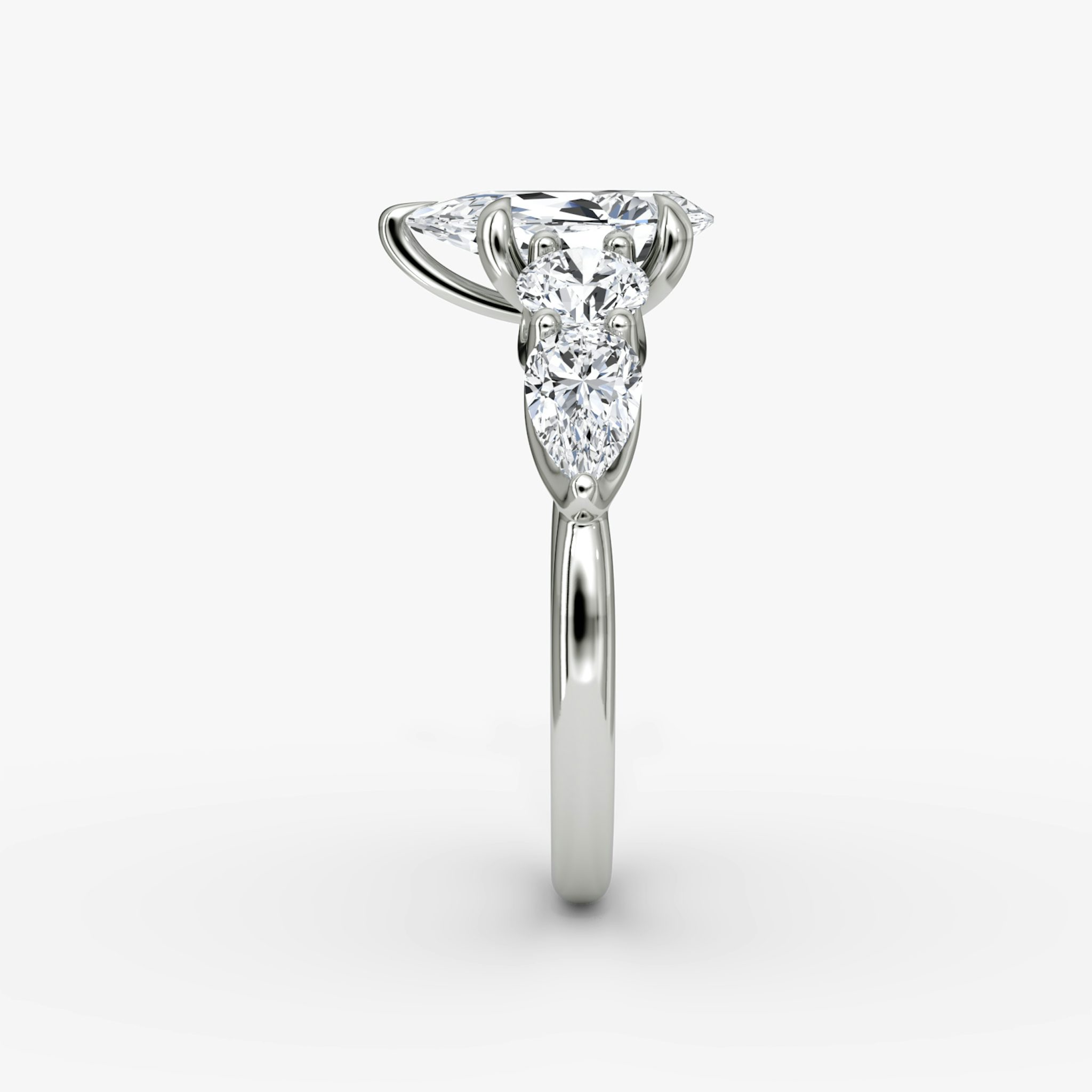 The Mixed Shape | Pear | 18k | White Gold | bandAccent: Plain | sideStoneOrientation: horizontal | sideStoneShape: Round Brilliant and Pear | diamondOrientation: vertical | caratWeight: other