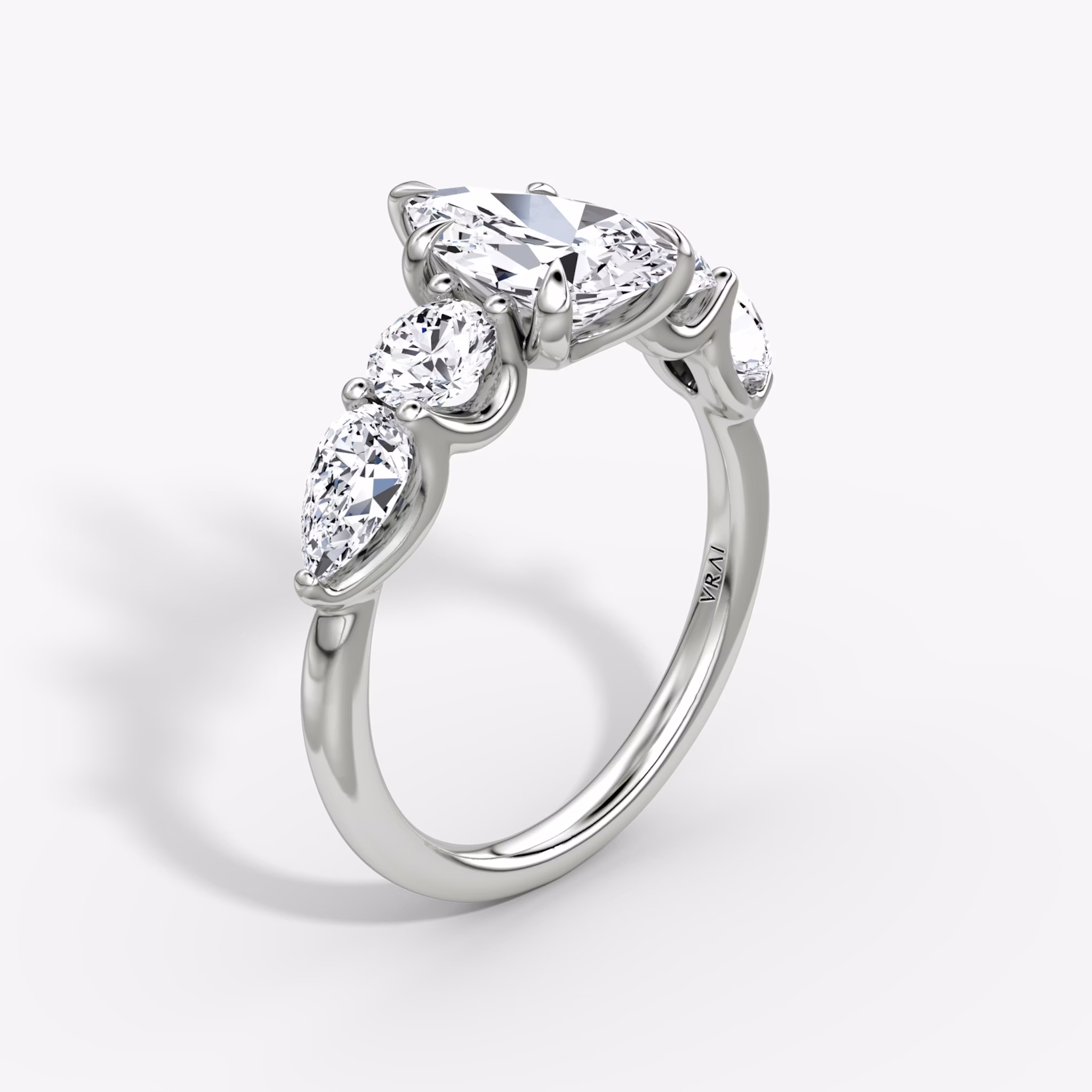 The Mixed Shape | Pear | 18k | White Gold | bandAccent: Plain | sideStoneOrientation: horizontal | sideStoneShape: Round Brilliant and Pear | diamondOrientation: vertical | caratWeight: other