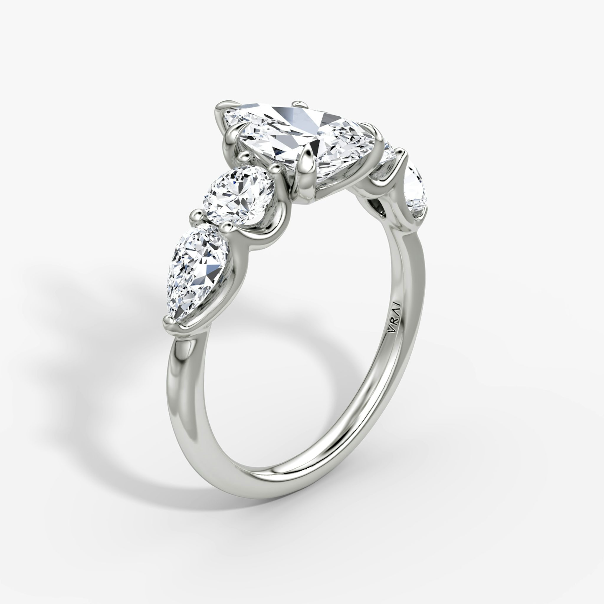 The Mixed Shape | Pear | 18k | White Gold | bandAccent: Plain | sideStoneOrientation: horizontal | sideStoneShape: Round Brilliant and Pear | diamondOrientation: vertical | caratWeight: other